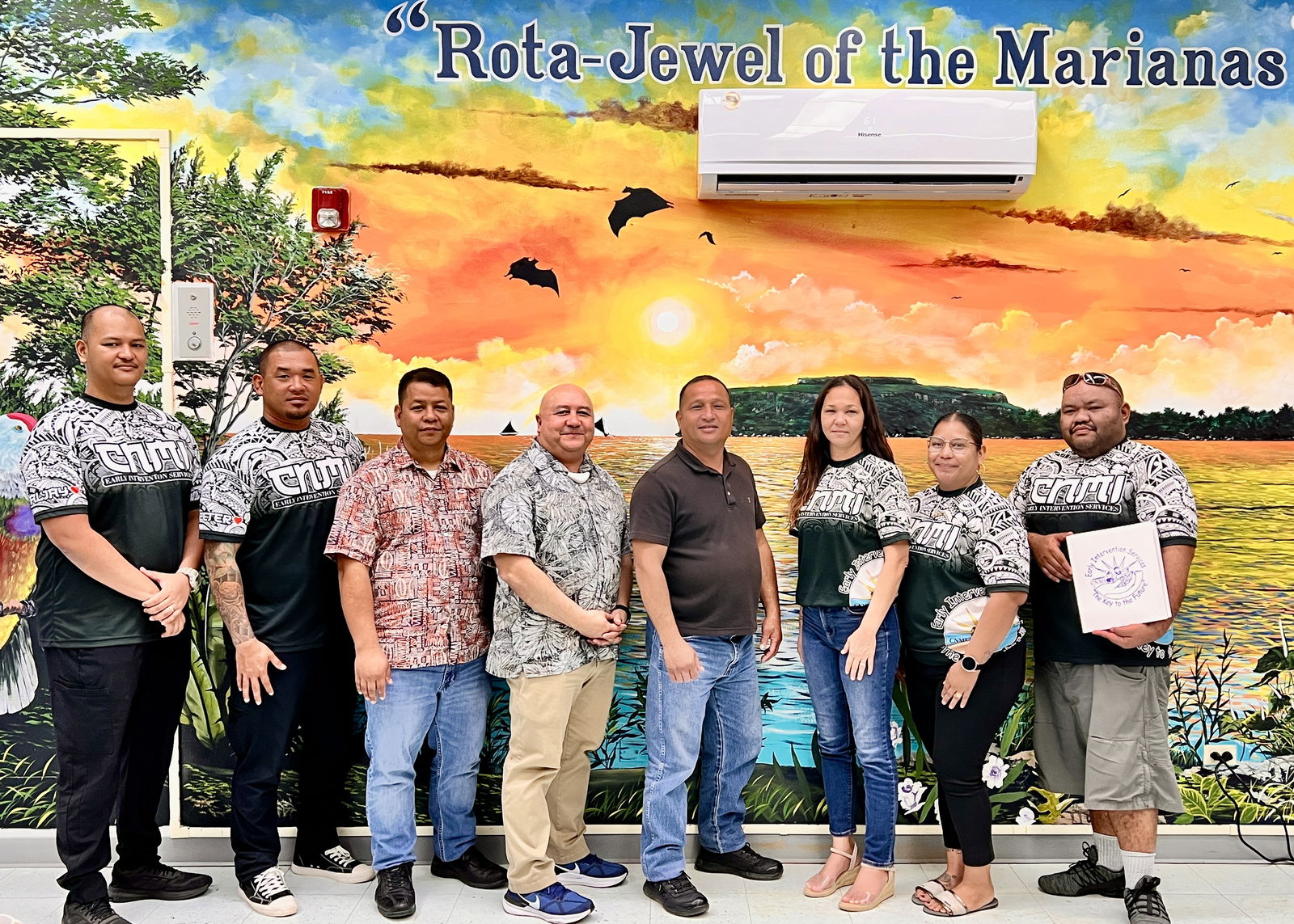 Acting Rota Mayor Jim Atalig, fourth right, and chief of staff Dean Reynold Manglona, third left, pose for a photo with Commissioner of Education Dr. Lawrence F. Camacho, Early Intervention Program Director Robin L. Palacios and some of her team members.