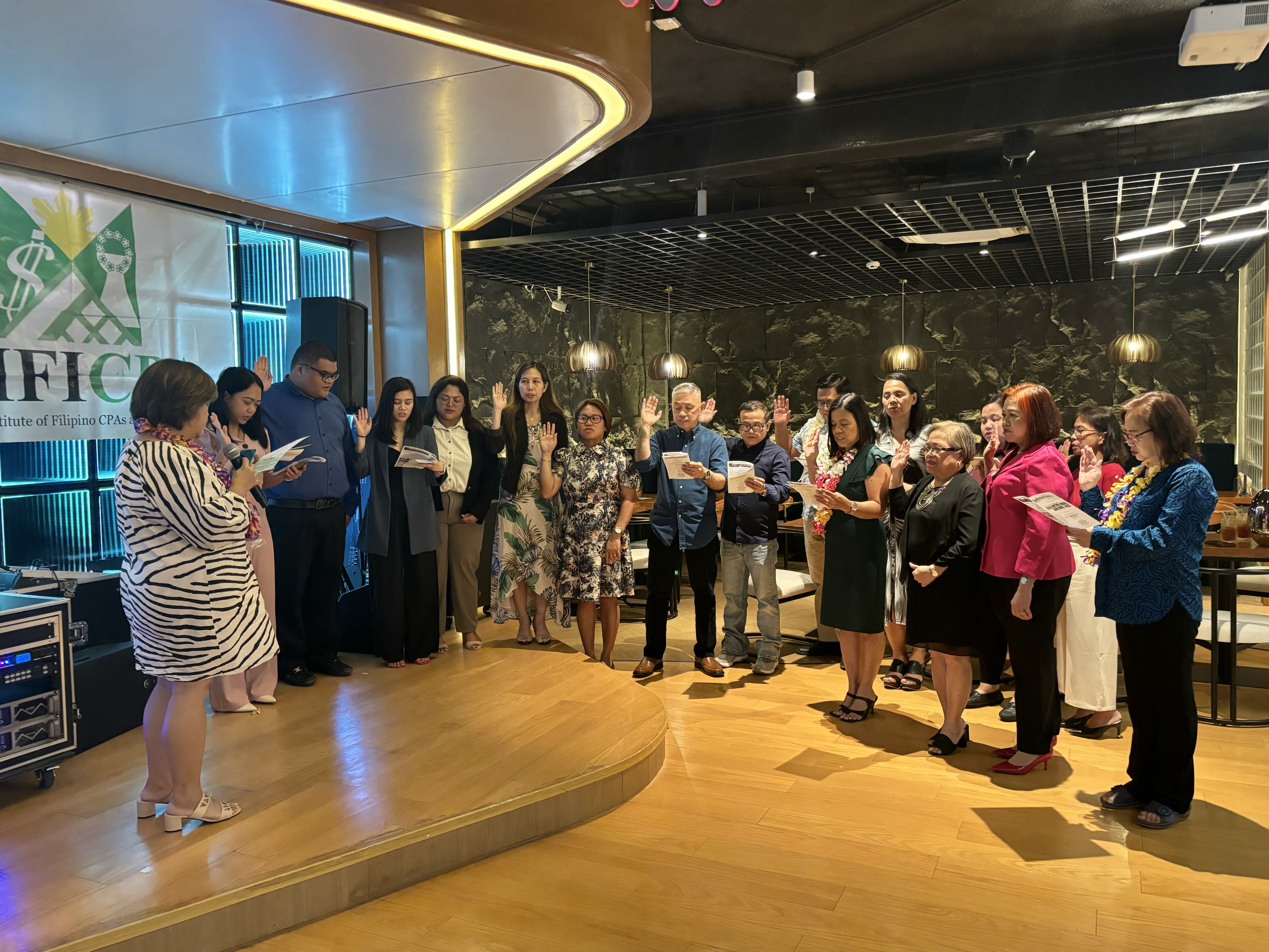 MJ Visions Inc. President Maria Dela Torre, far left, inducts the new members of the Marianas Institute of Filipino Certified Public Accountants.