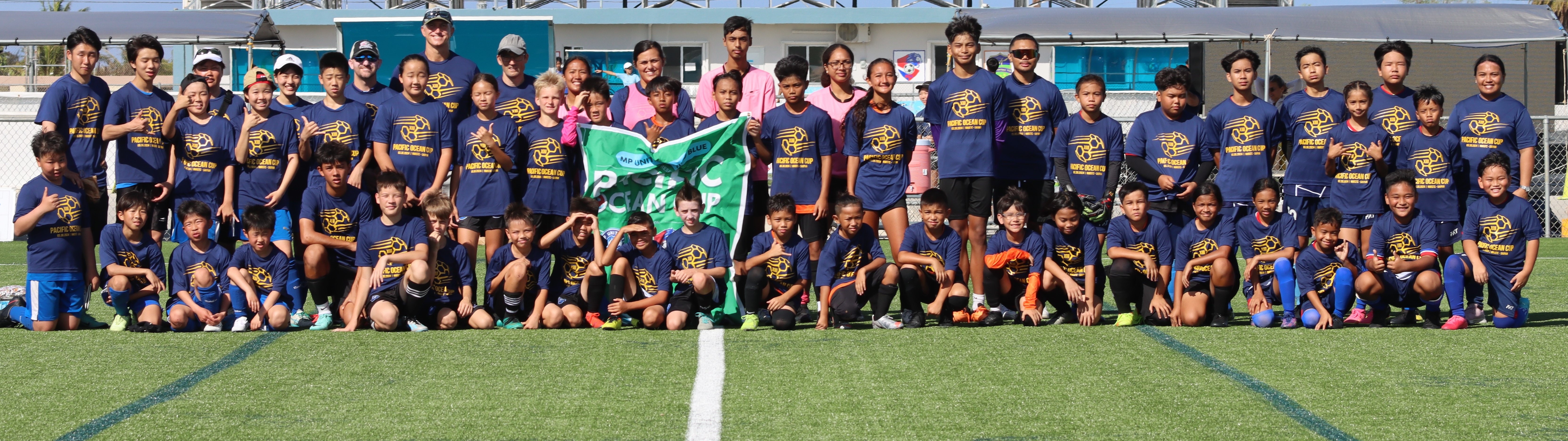 Pacific Ocean Cup XIII participants pose for a group photo at the NMI Soccer Training Center in Koblerville on Saturday.