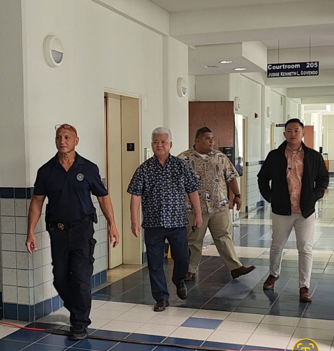 Gov. Arnold I. Palacios, 2nd left, walks toward Courtroom 220A to testify in the bench trial of Chief of Parole Nick Masga Reyes.