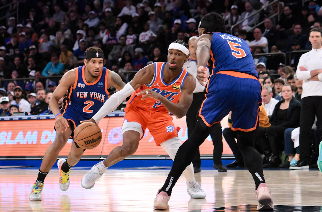 Oklahoma City Thunder guard Shai Gilgeous-Alexander (2) drives while being defended by New York Knicks guard Miles McBride (2) and New York Knicks forward Precious Achiuwa (5) during the third quarter at Madison Square Garden in New York on March 31, 2024.