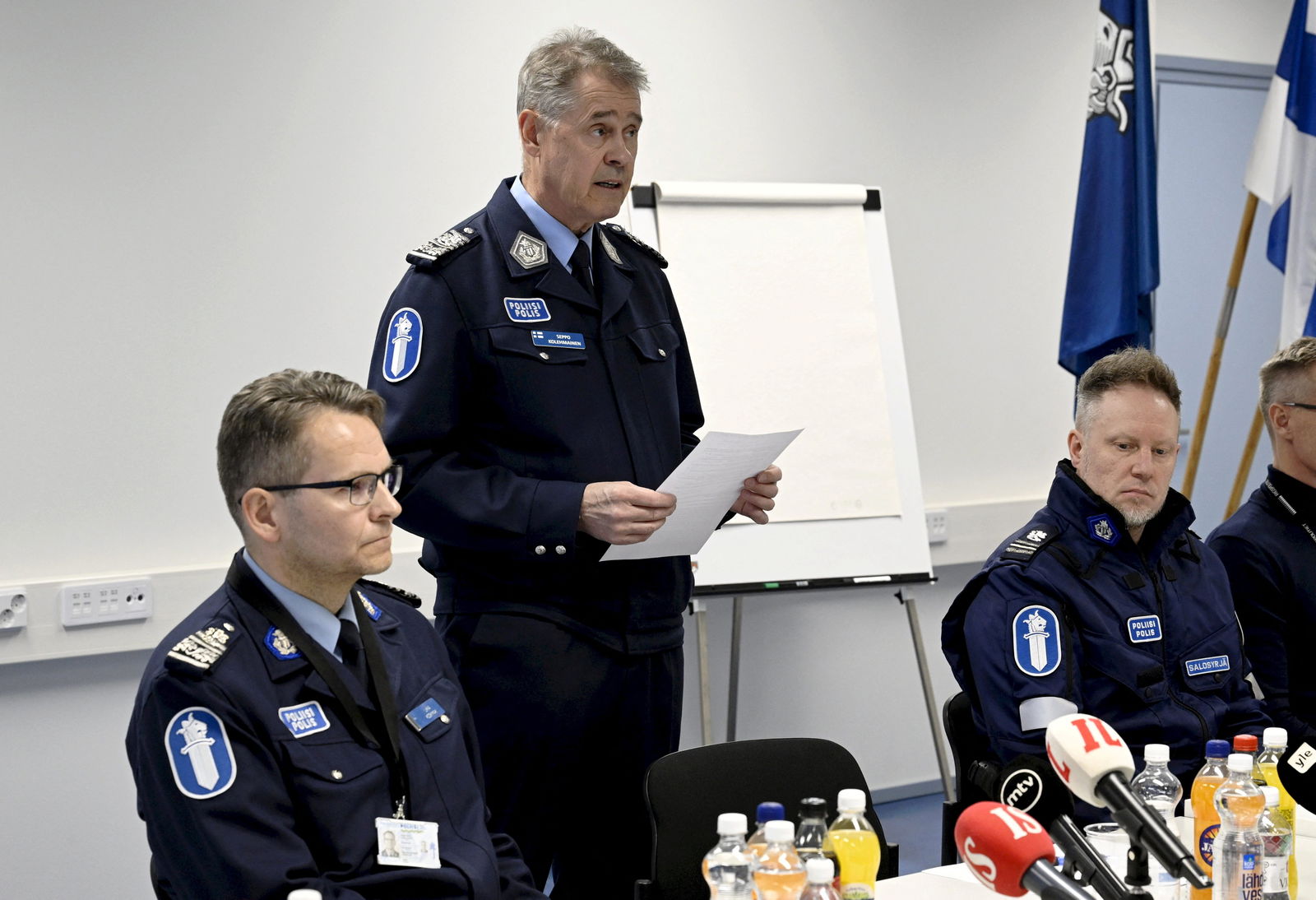 National Police Commissioner Seppo Kolehmainen speaks while Police Chief Ilkka Koskimaki and Inspector Tomi Salosyrja look on during a police press conference on the Viertola school shooting incident in Vantaa, Finland, on April 2, 2024. One sixth grade pupil died and two others were seriously injured in the Vantaa school shooting on Tuesday. 