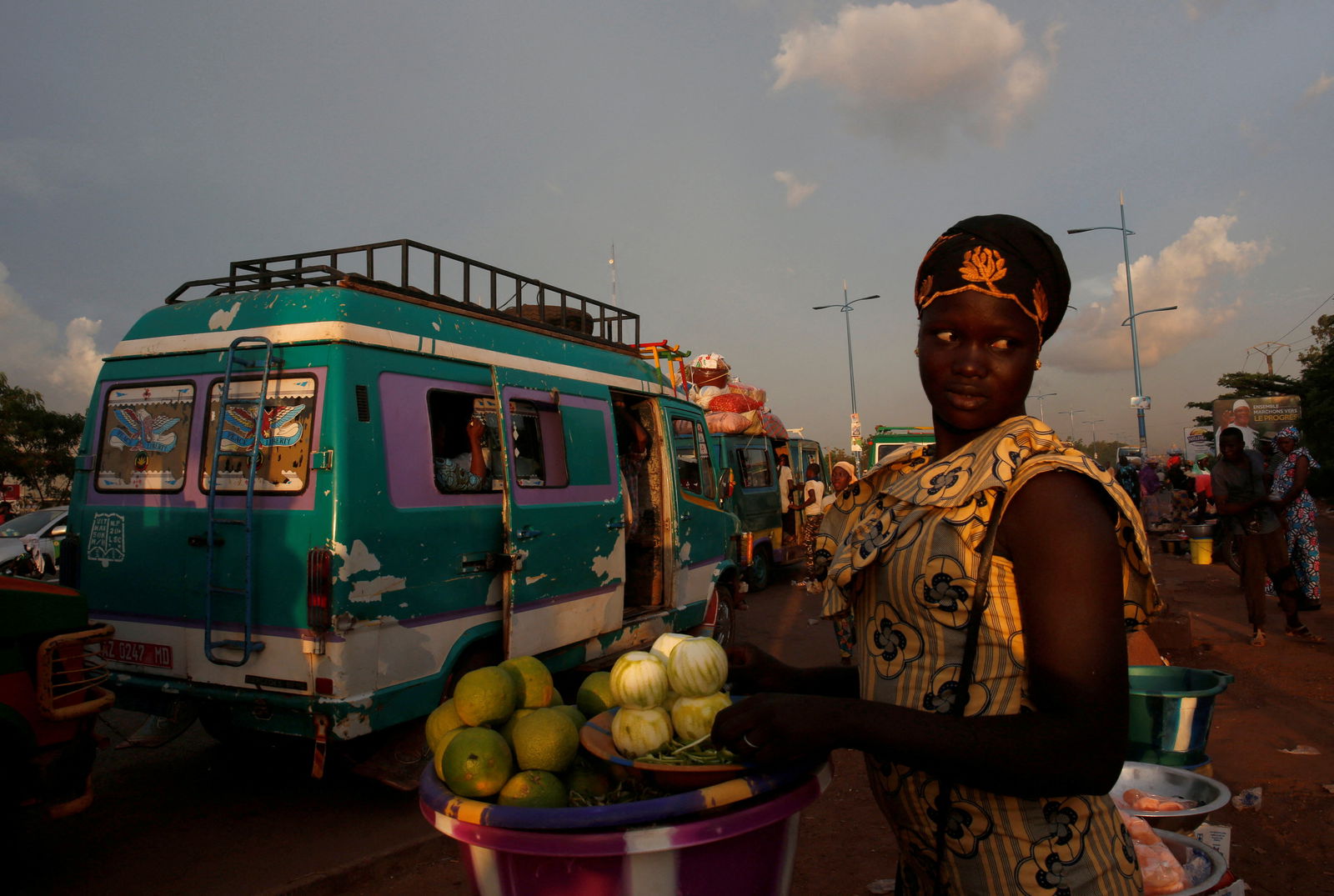 FILE PHOTO: A street vendor sells oranges at a mini bus station in Bamako, Mali. July 24, 2018. 
