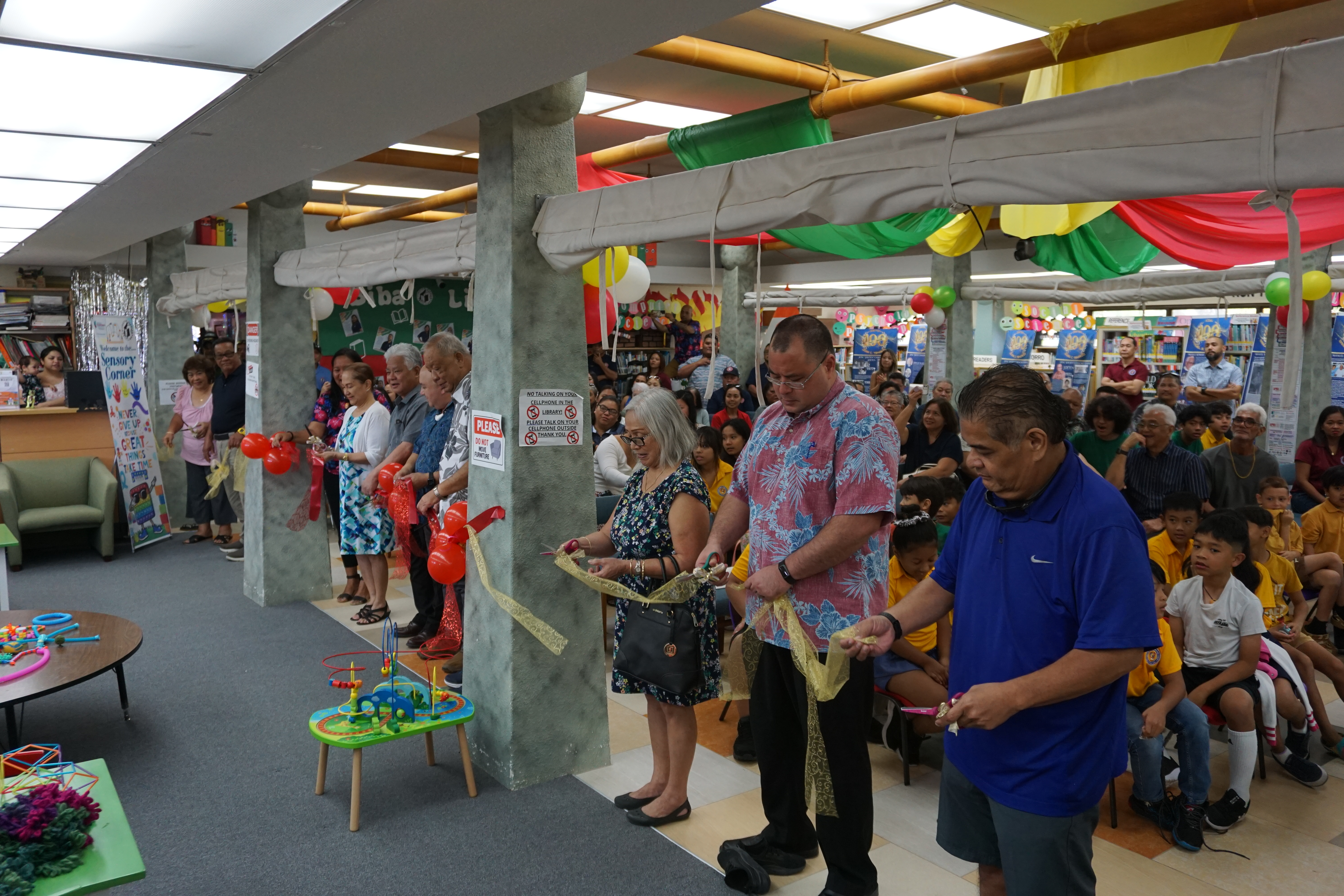 CNMI officials led by Gov. Arnold I. Palacios and Lt. Gov. David M. Apatang cut the ceremonial ribbon at JKPL’s Sensory Corner.​​