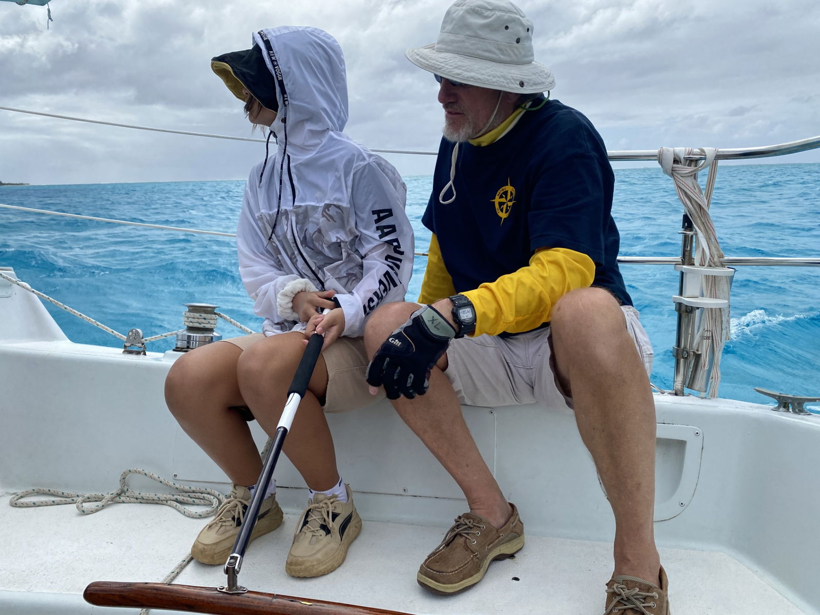 Sea Cadet Hedy Fu mans the tiller under the supervision of Capt. Michael Bacher.