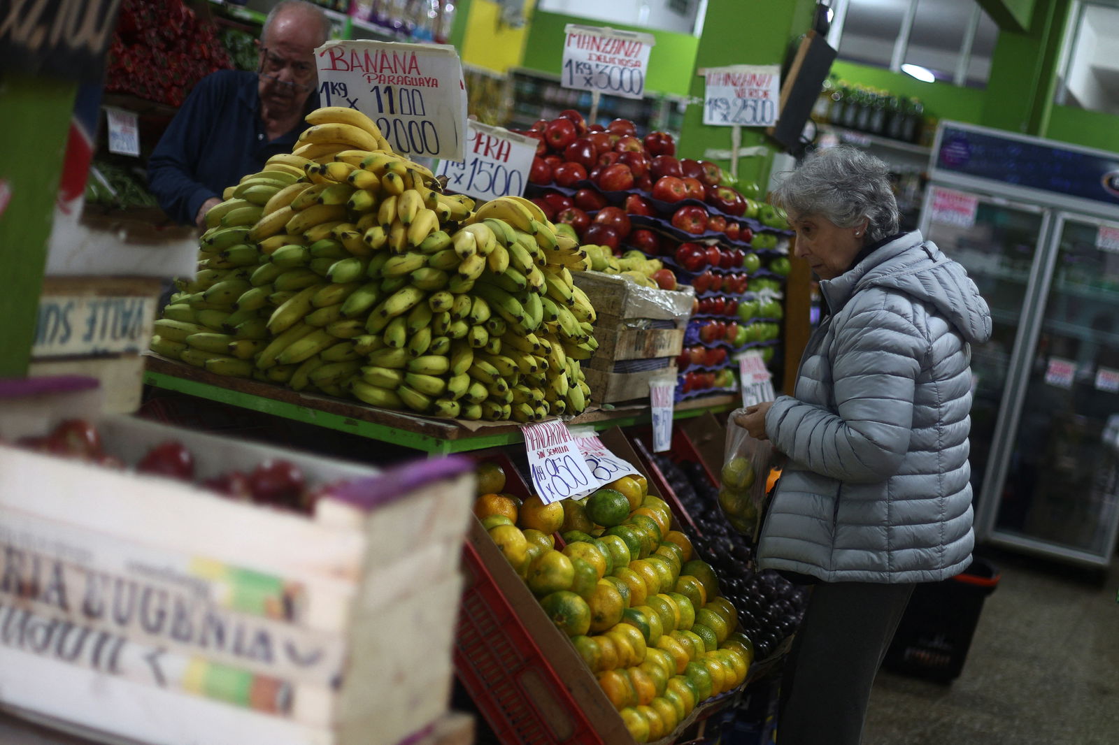 A shopper looks at produce in a market, as Argentina is battling inflation that is running on an annual basis above 275%, in Buenos Aires, Argentina, April 11, 2024.