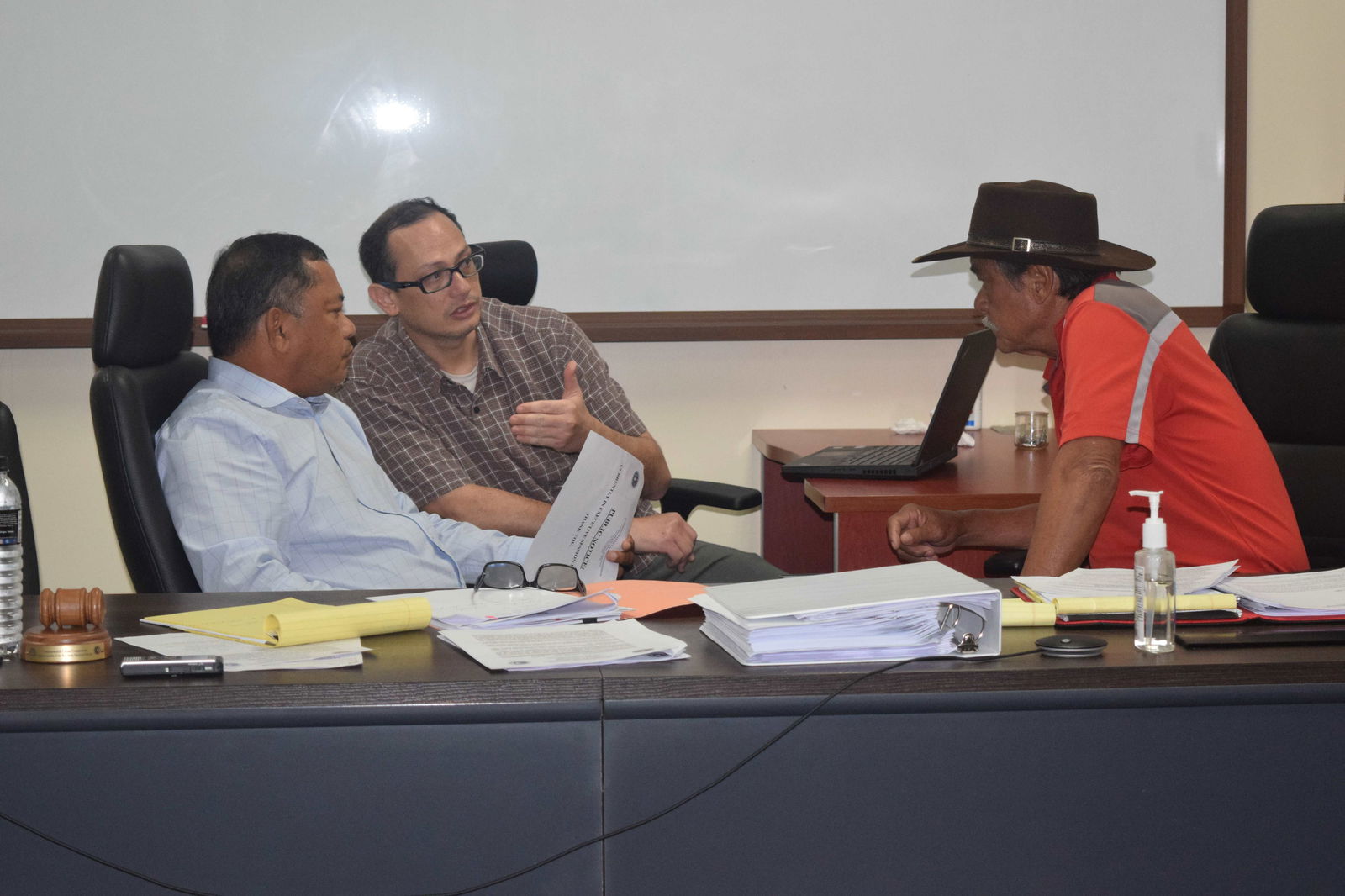 Acting Commonwealth Casino Commission Chairman Ralph S. Demapan, left, and Commissioner Ramon Dela Cruz, right, listen to Assistant Attorney General Carl Dela Cruz during a meeting on Wednesday.
