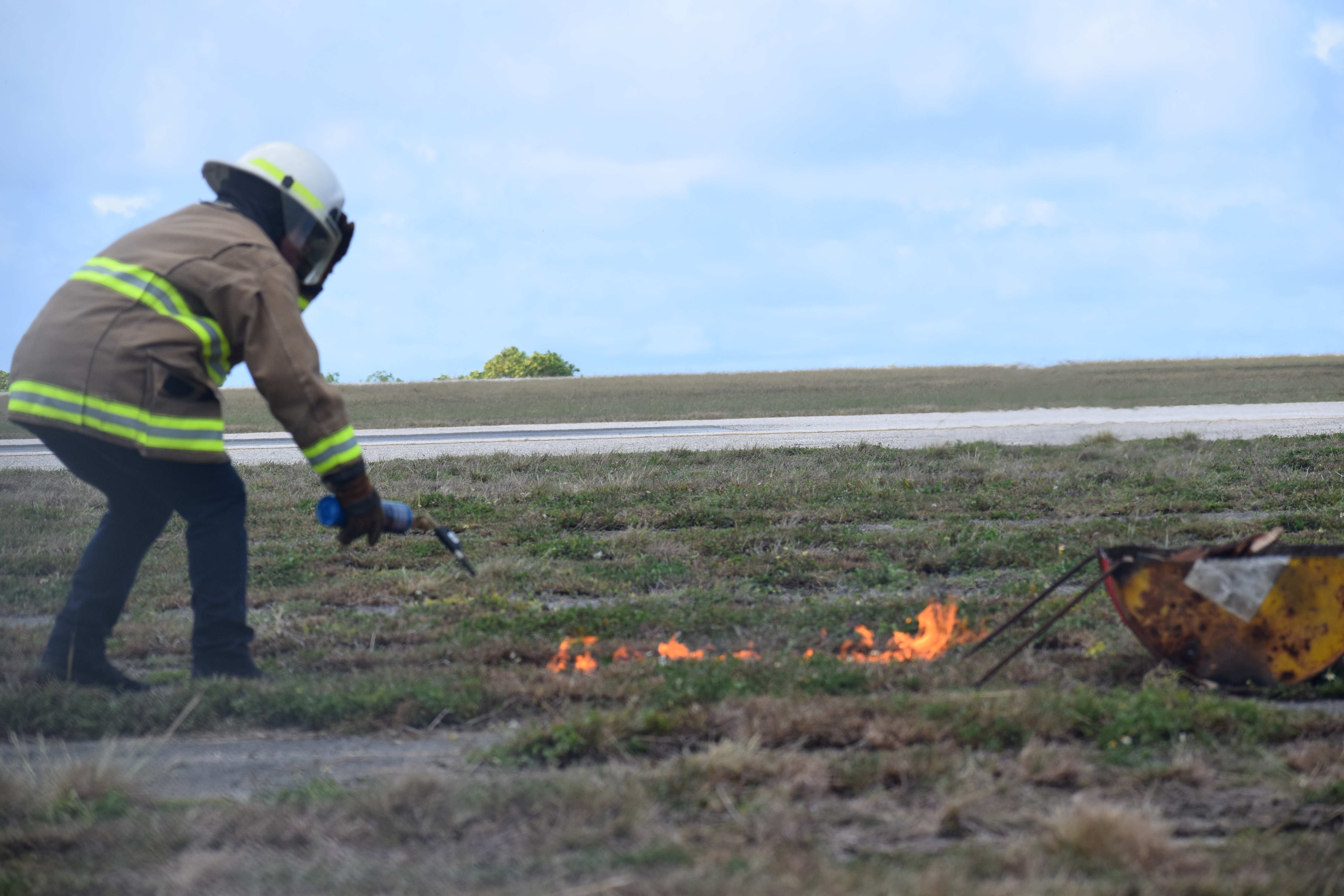 Department of Fire and Emergency Medical Services Commissioner Juan A. Pua ignites a controlled fire at the “crash site.”