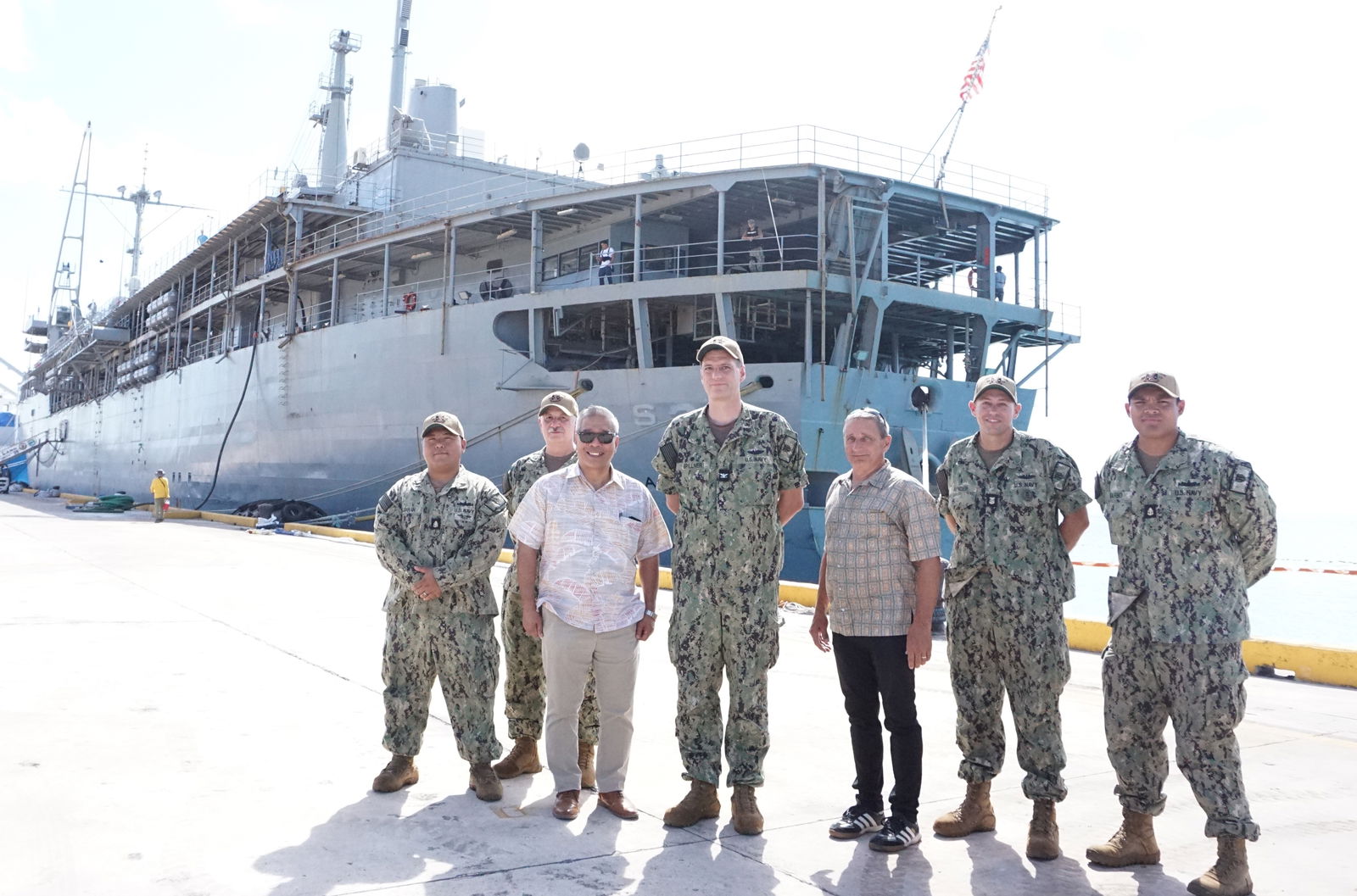 USS Emory S. Land commanding officer, Capt. Brent Spillner, center, executive officer, Commander Michael Fasano, second left, Command Master Chief Jonathan Render, second right, Chief Navy Engineman Mark Guiawan, left, and Chief Petty Officer Kevin Barbo pose for a photo with the special assistant to the governor for military affairs, Danny Aquino, and Commonwealth Bureau of Military Affairs policy advisor, Tom Linden, at the Port of Saipan on Wednesday.