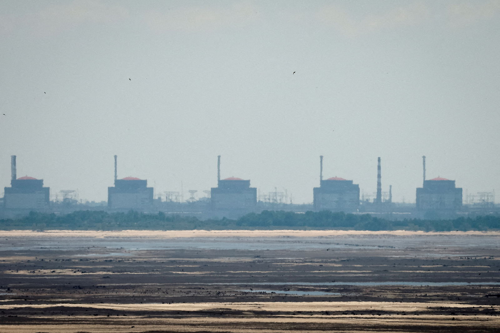 FILE PHOTO: A view shows Zaporizhzhia Nuclear Power Plant from the bank of Kakhovka Reservoir near the town of Nikopol after the Nova Kakhovka dam breached, amid Russia's attack on Ukraine, in Dnipropetrovsk region, Ukraine June 16, 2023. 