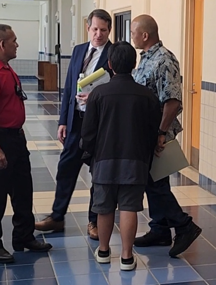 Chief of Parole Nick Masga Reyes, right, confers with his attorney, Matthew Holley, during a break from Reyes’s bench trial on Wednesday.