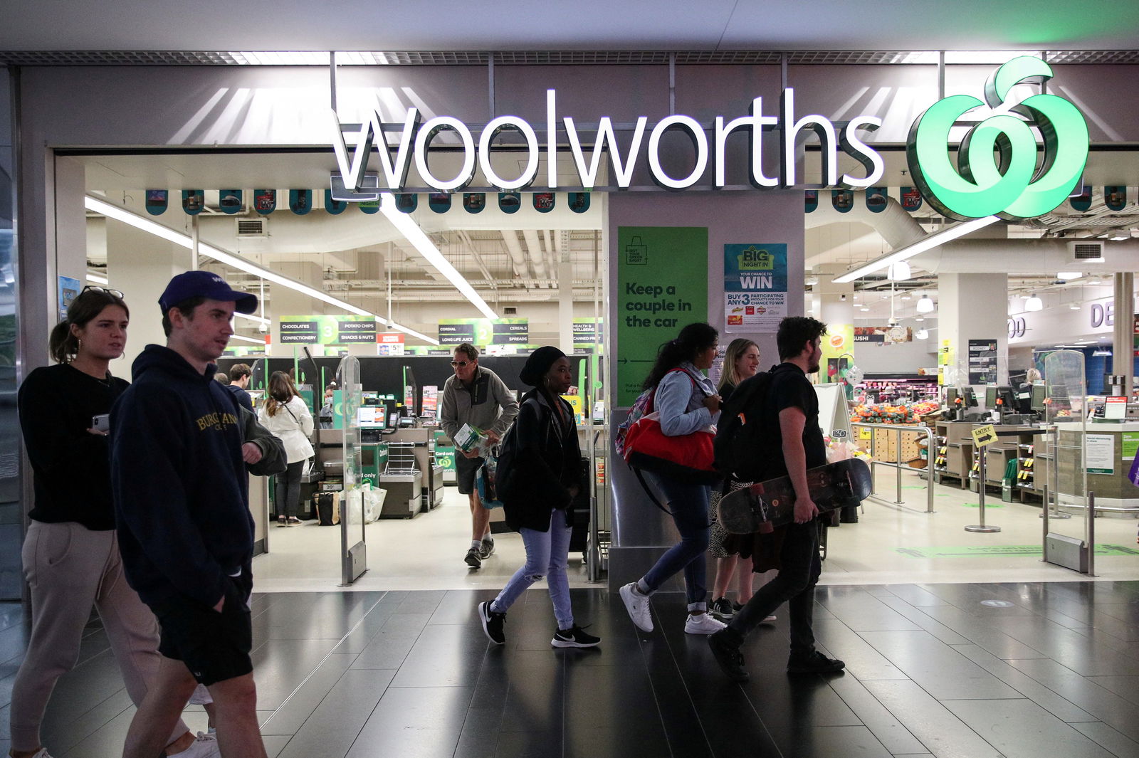 FILE PHOTO: People walk past a Woolworths supermarket in Sydney, Australia, June 16, 2020. Picture taken June 16, 2020. 