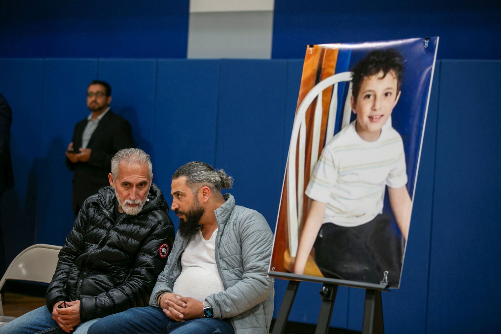 Oday Al-Fayoume, Wadea Al-Fayoume's father speaks to his uncle during a vigil service at the Prairie Activity & Recreation Center for Wadea Al-Fayoume, 6, a Muslim boy who according to police was stabbed to death in an attack that targeted him and his mother for their religion and as a response to the war between Israel and Hamas, in Plainfield, Illinois, U.S. October 17, 2023. 
