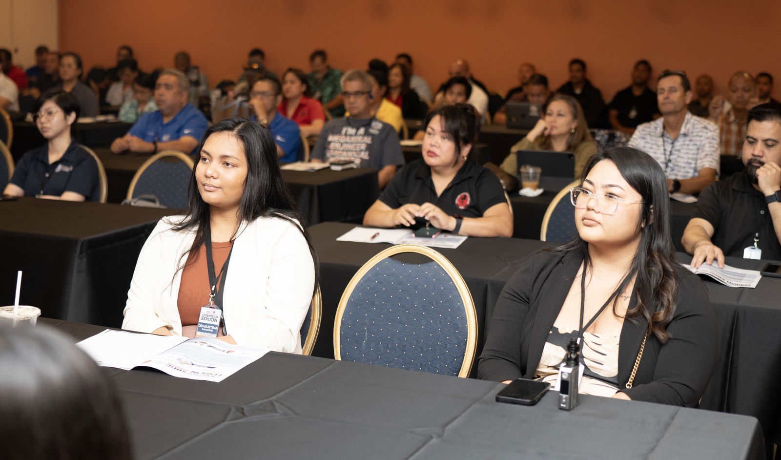 Summit attendees listen to a presentation on utilizing IT to improve modern day workflow strategies.