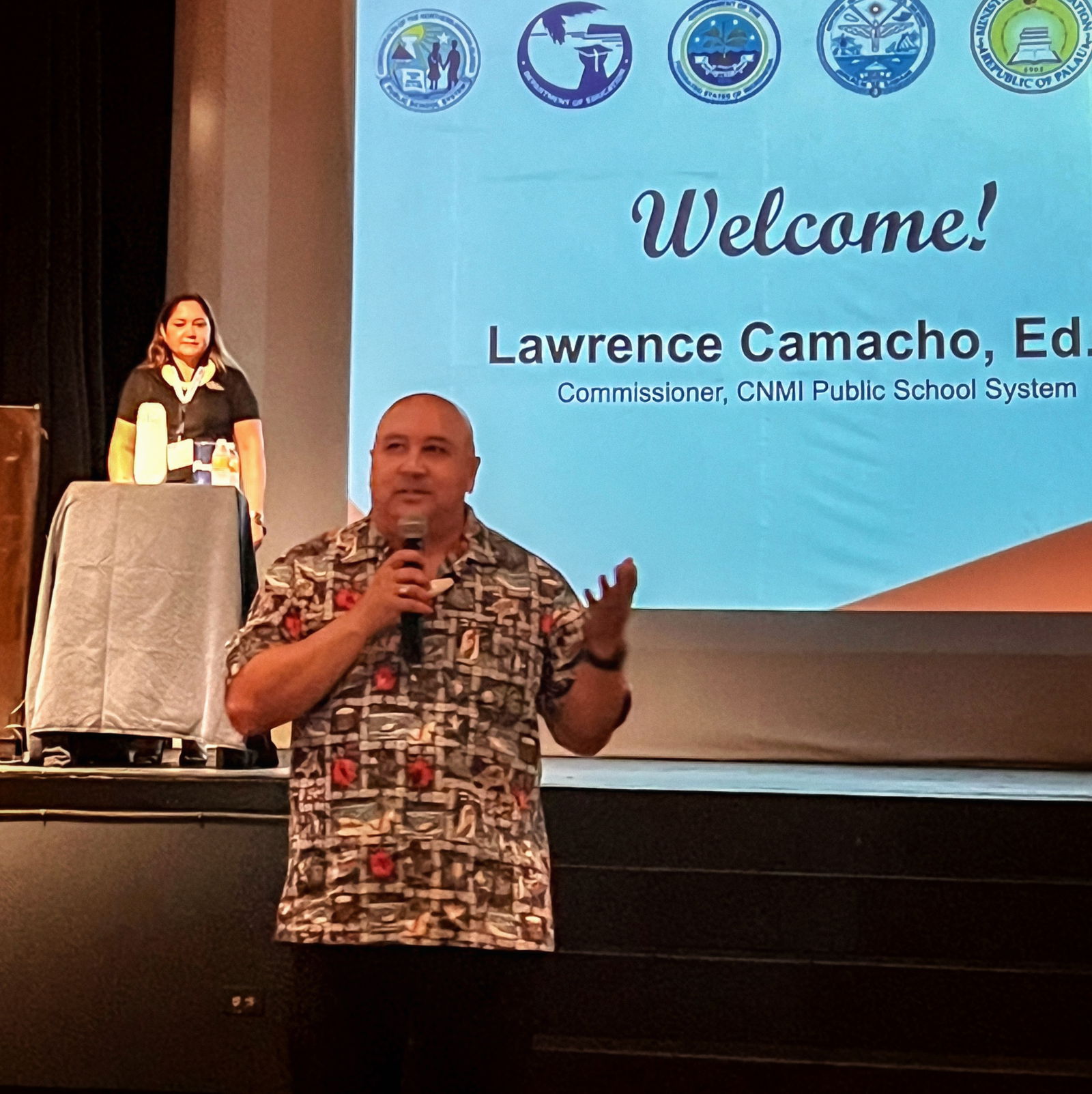 Commissioner of Education of Dr. Lawrence F. Camacho delivers his remarks while Special Education State Director Donna M. Flores listens.