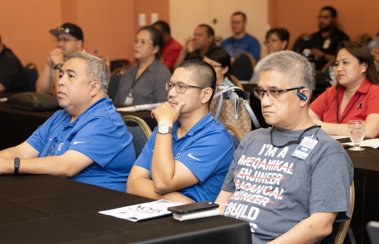 Summit attendees listen to a presentation on utilizing IT to improve modern day workflow strategies.