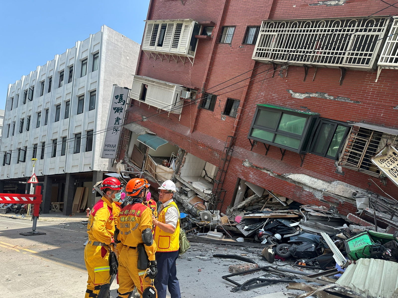 Firefighters work at the site where a building collapsed following the earthquake, in Hualien, Taiwan, in this handout provided by Taiwan's National Fire Agency on April 3, 2024. 