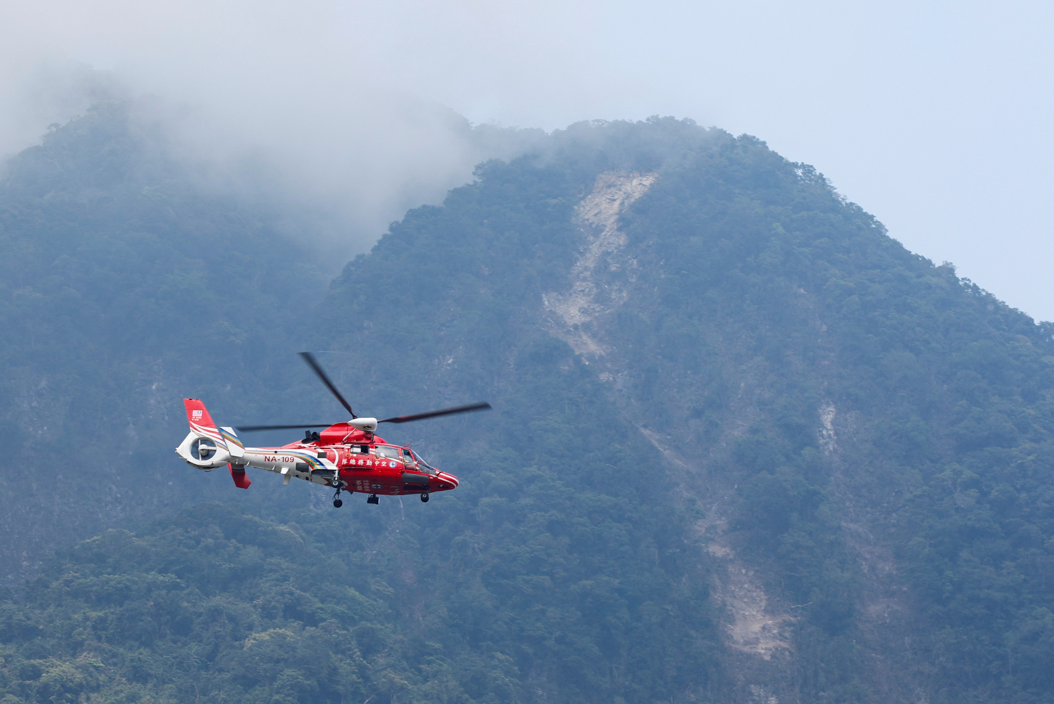 A rescue helicopter flies past the area of a landslide, following the earthquake, in Hualien, Taiwan, April 4, 2024. 