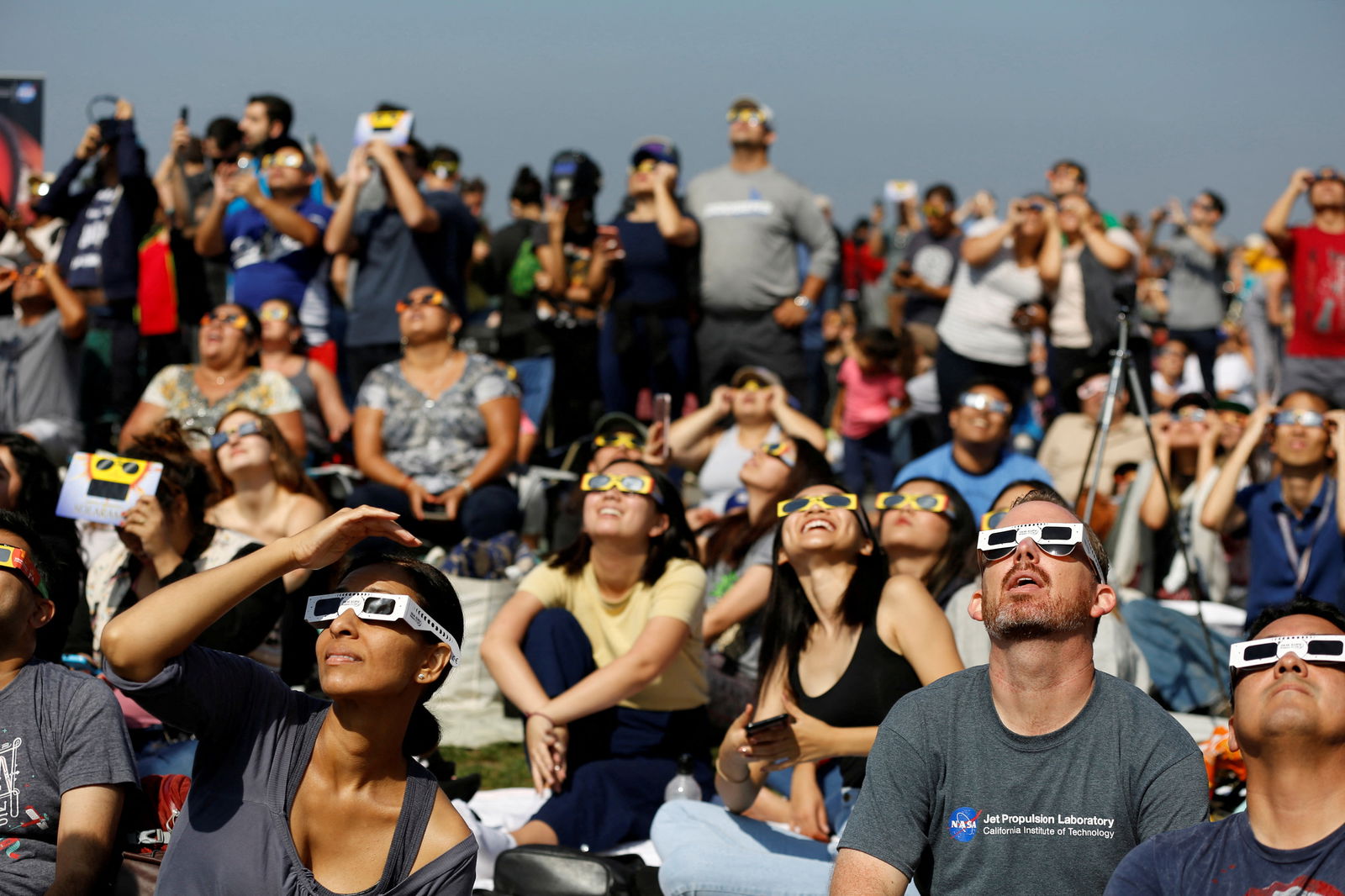 FILE PHOTO: People watch the solar eclipse on the lawn of Griffith Observatory in Los Angeles, California, U.S., August 21, 2017. 