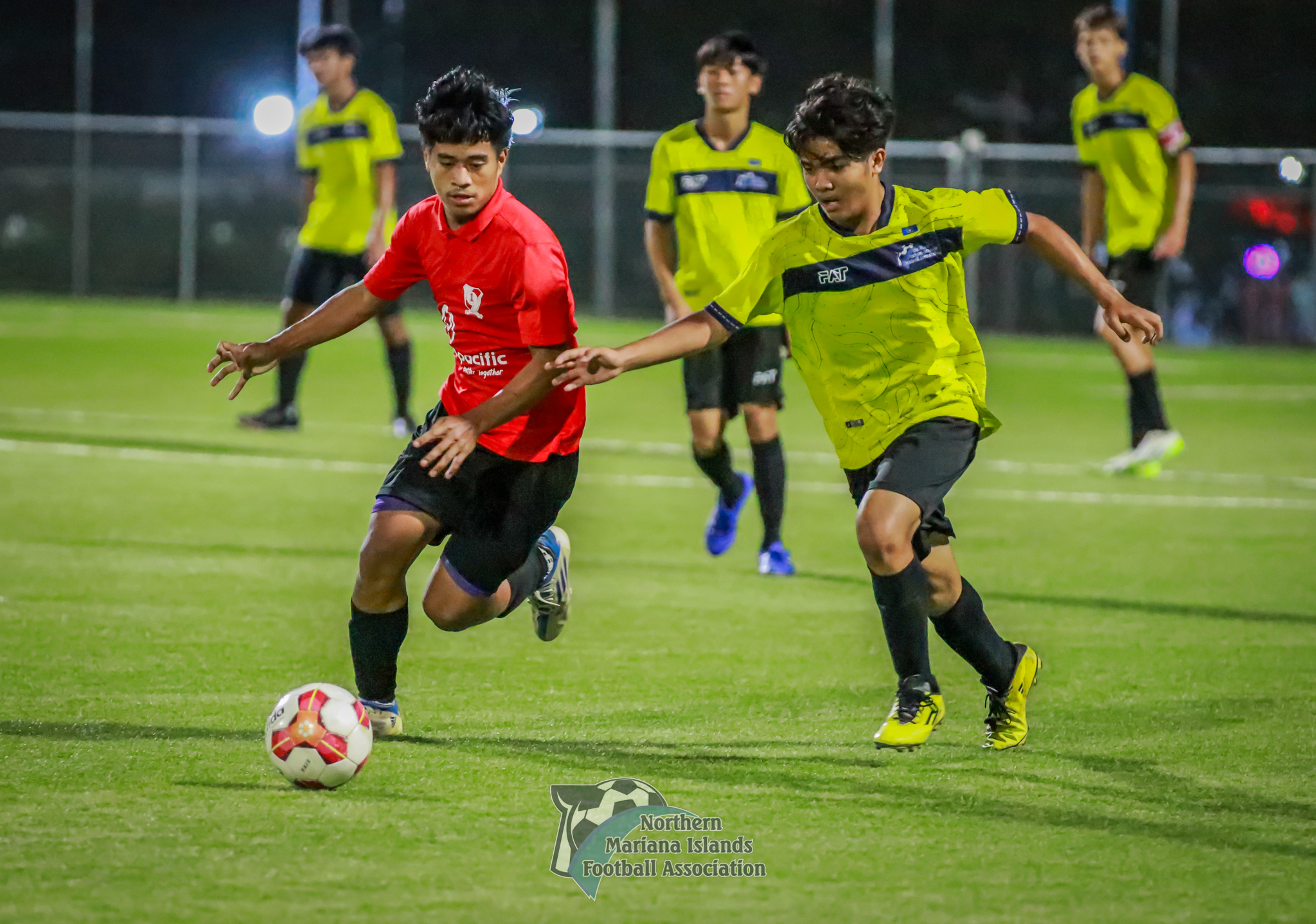 Paire FC's Heman Addy slips past a Men's Development Team player during a Marianas Soccer League 1 game at the NMI Soccer Training Center on Wednesday.