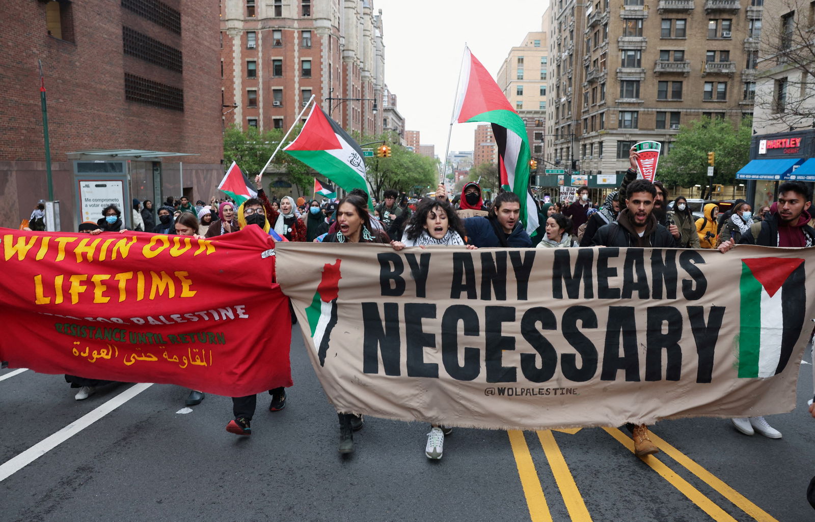 Demonstrators holding a banner protest in solidarity with Pro-Palestinian organizers as they block a street, amid the ongoing conflict between Israel and the Palestinian Islamist group Hamas, in New York City, April 18, 2024.
