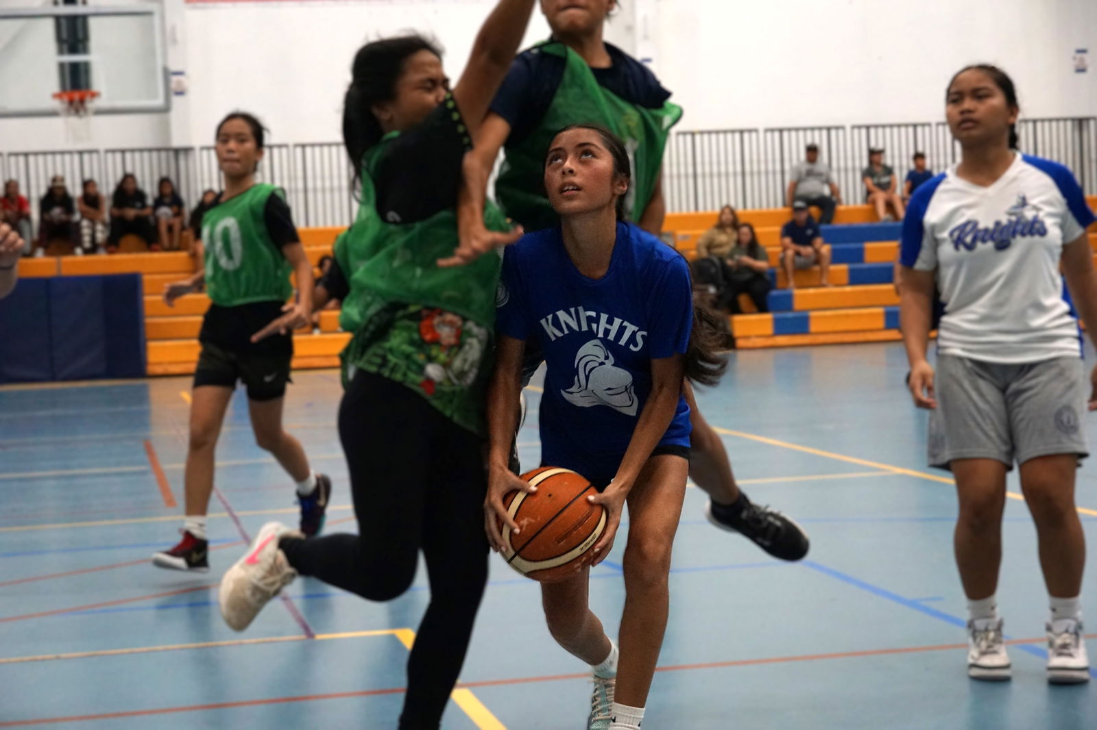 Mount Carmel School's Aubrey Quitugua gets fouled as she goes up for the shot during a girls middle school division game of the IT&E Interscholastic Basketball League SY23-24 at the Marianas High School gym.