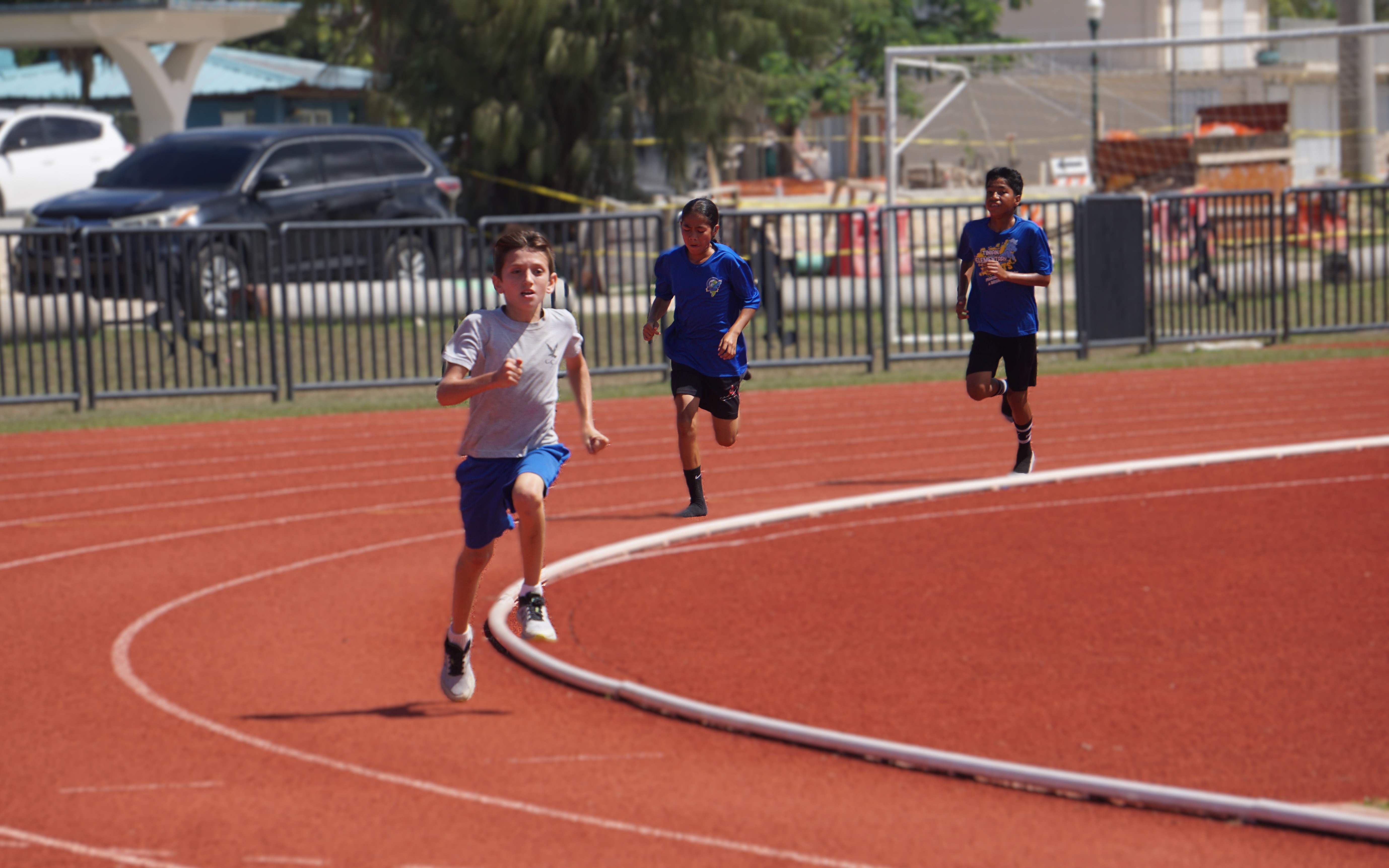 Grace Christian School's Beau Bauer takes the lead in the U12 boys 1,500m event of the PSS All School Track & Field (Athletics) SY23-24 at the Oleai Sports Complex on Saturday morning.