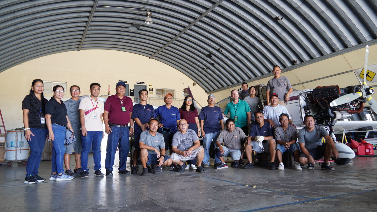 Shaun Christian (in green shirt) with SMA team in Tinian Hangar
