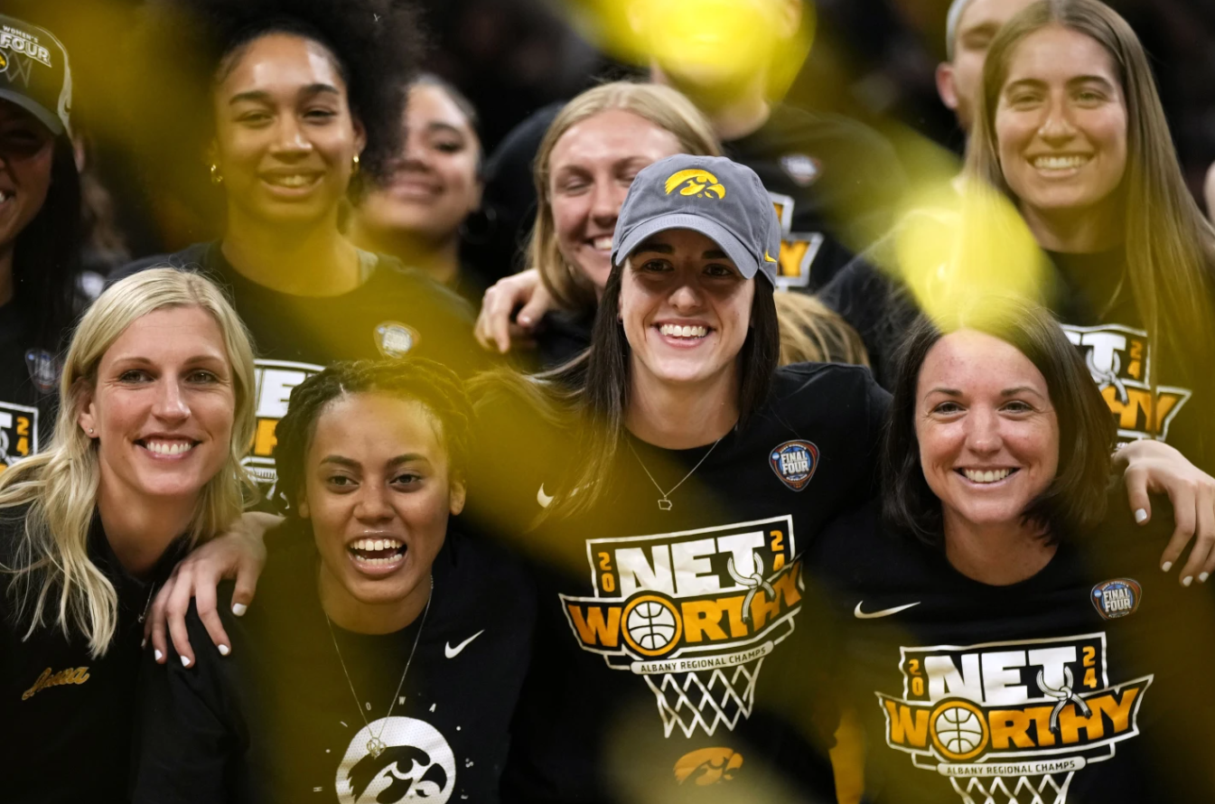 Iowa guard Caitlin Clark, center, poses for photos with teammates and coaches during an Iowa women’s basketball team celebration Wednesday, April 10, 2024 in Iowa City, Iowa.