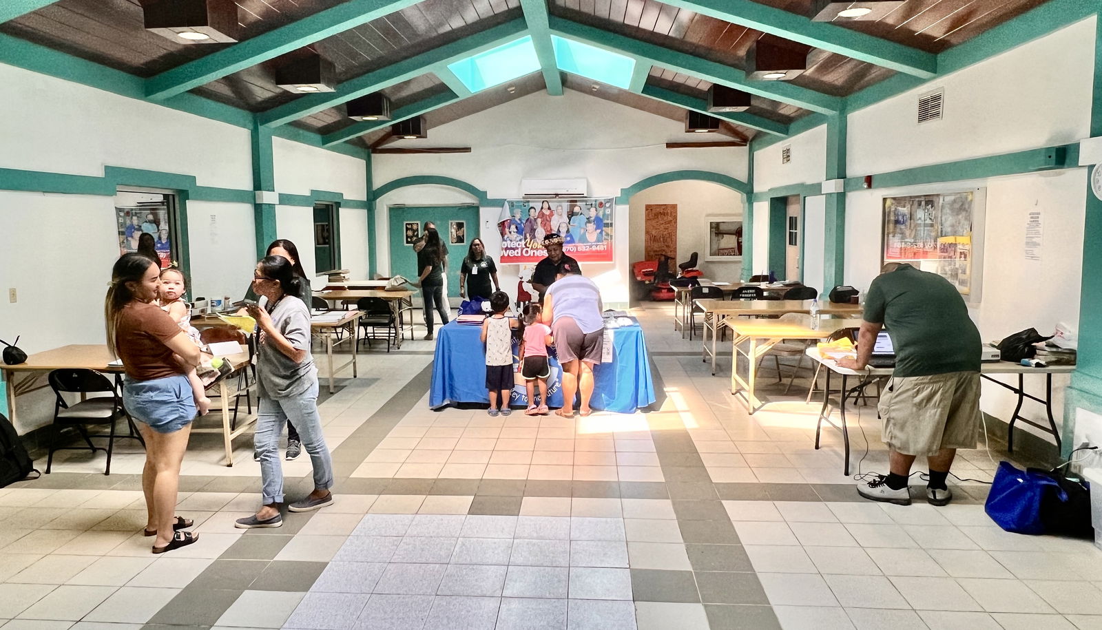 At the Rota Office on Aging, specialists from the PSS Early Intervention Program talk to parents who walked in to sign up for free early detection program services.