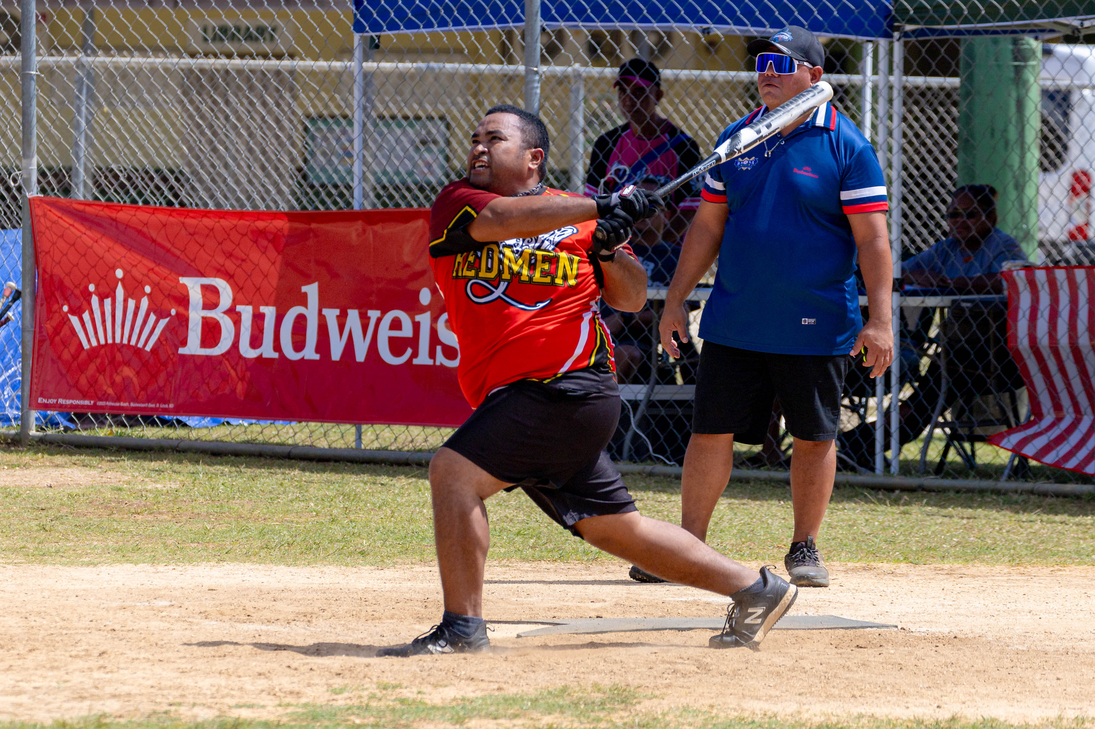 The Redmen's Aling Ogumoro connects a two-run homer during a masters division game of the 2024 Budweiser Belau Amateur Softball Association League at the Dandan baseball field on Sunday.