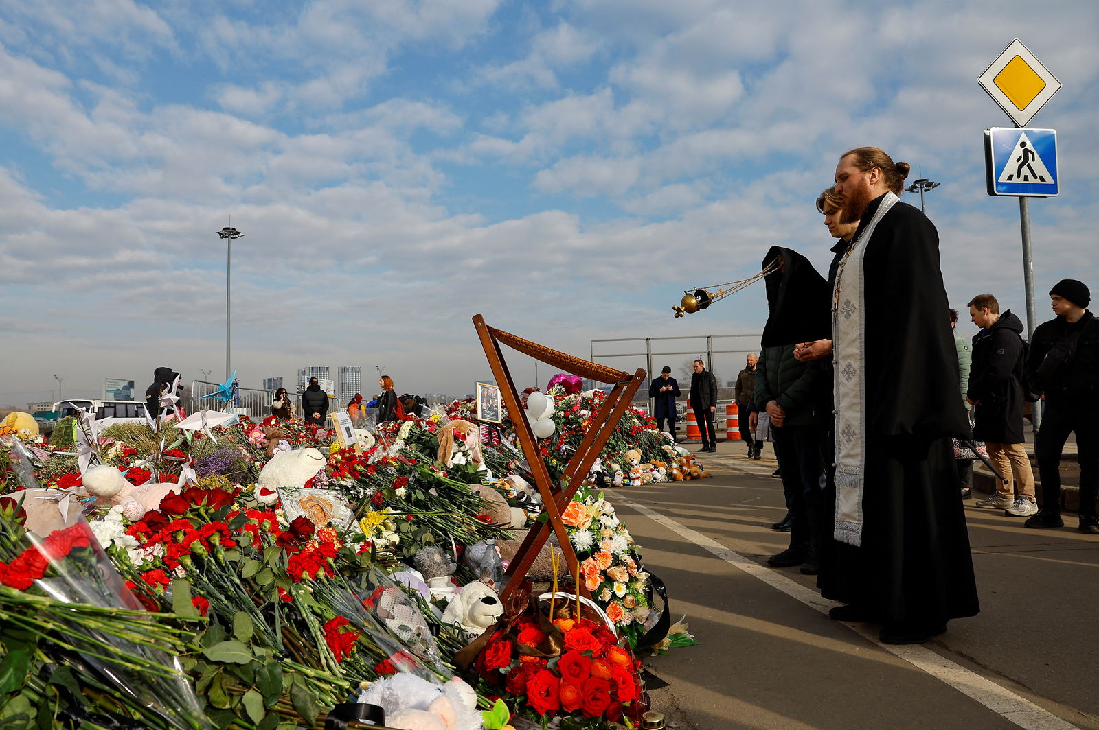 Clergymen conduct a memorial service for victims at a makeshift memorial near the Crocus City Hall following a deadly attack on the concert venue outside Moscow, Russia, March 29, 2024. 