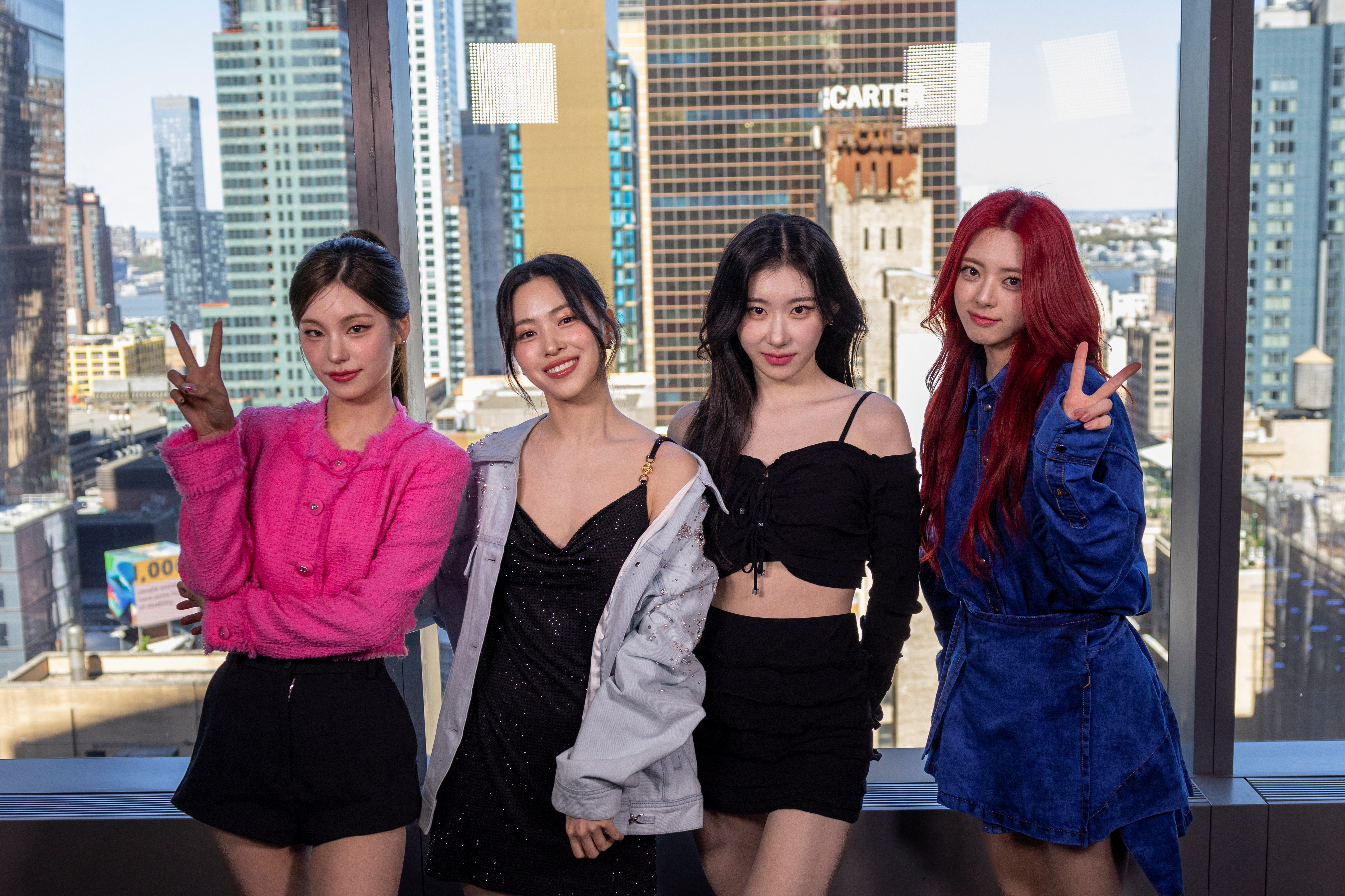 Members of the group ITZY pose in front of the Manhattan skyline during an interview with Reuters in New York, April 22, 2024.