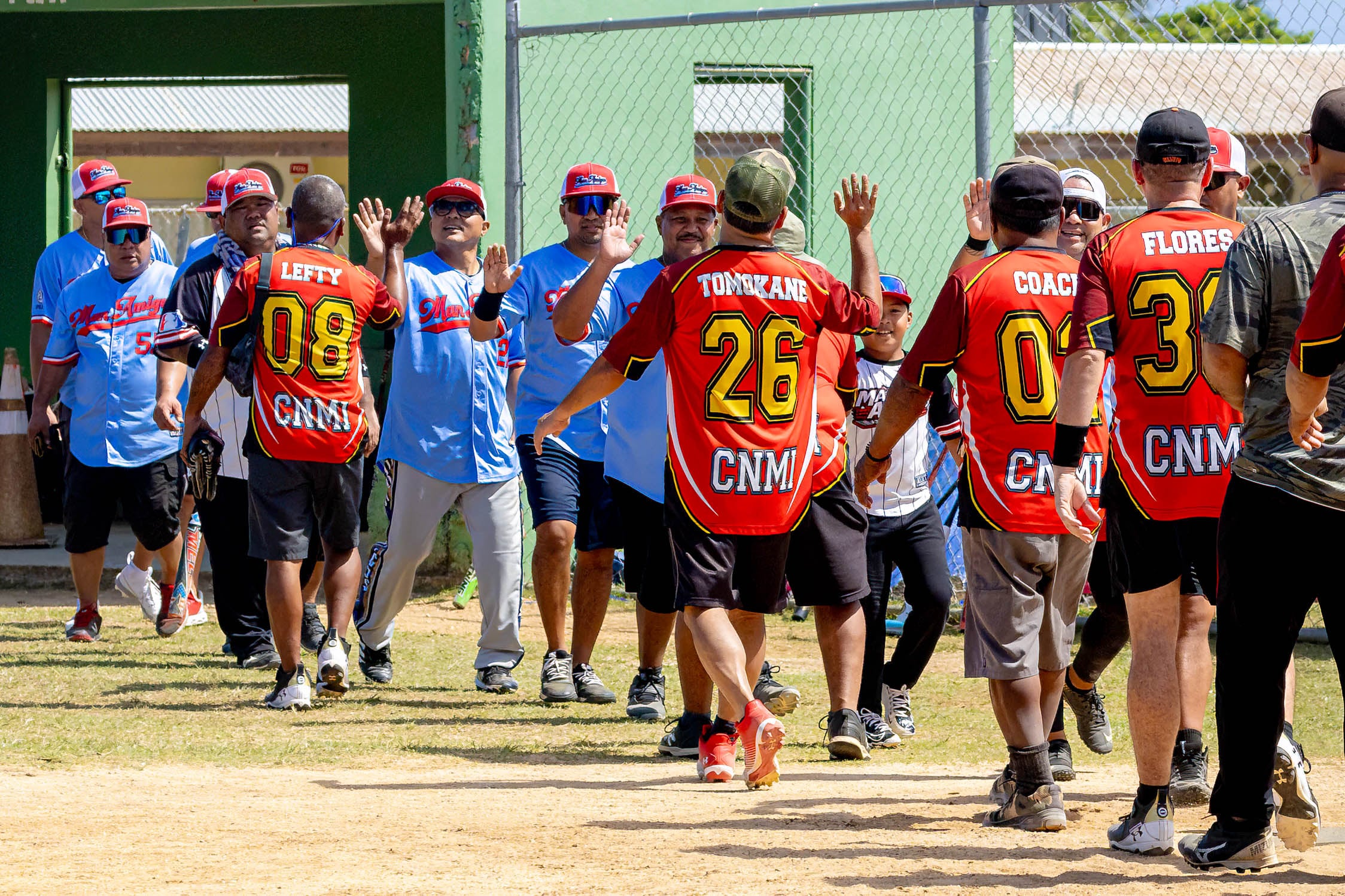 The Man Amigos and Redmen exchange hi-fives after the game.