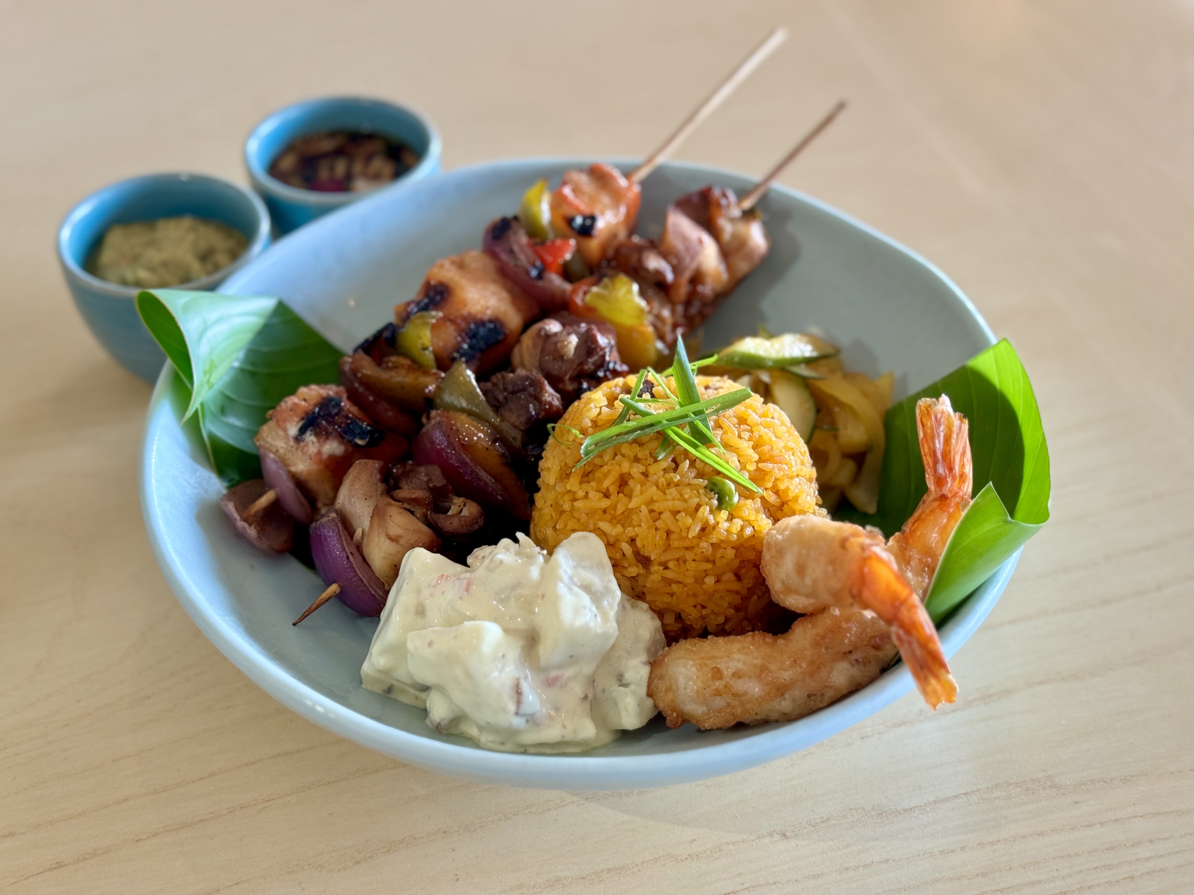Loco Local BBQ Street Market’s red rice, potato salad and pork BBQ sticks.