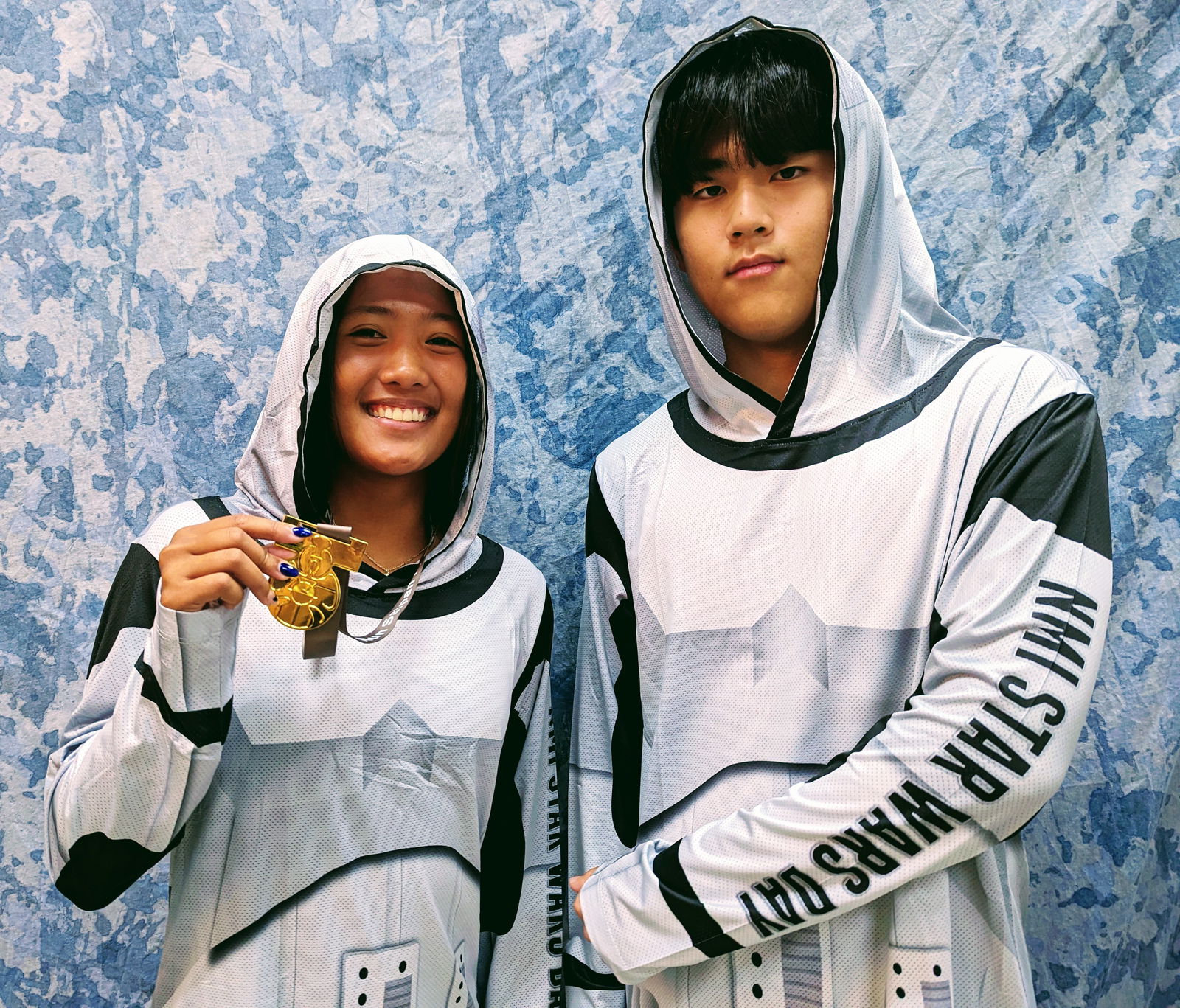 Wearing the Imperial Stormtrooper Armor Hoodie and showing off the Medal of Bravery, cross country and track runners Kaithlyn Chavez and Junseo Kim are ready for the Star Wars Day Run/Walk on May 4, 2024.