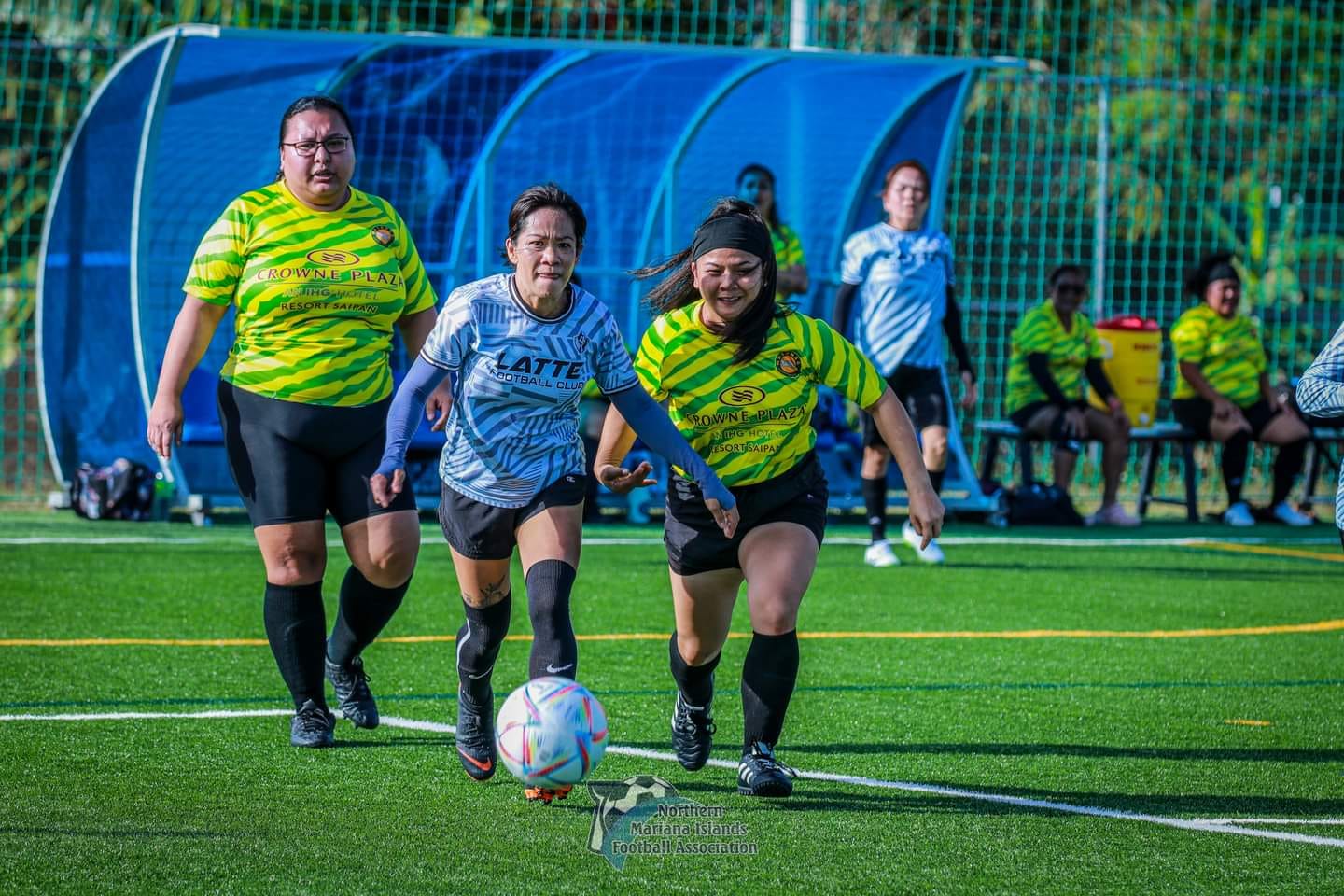 Latte FC 1's Rosemarie Chisato dribbles past two Matansa FC 2 defenders during a Simiya-Faayul division game of the Spring 2024 Dove Women's League at the NMI Soccer Training Center on Sunday.