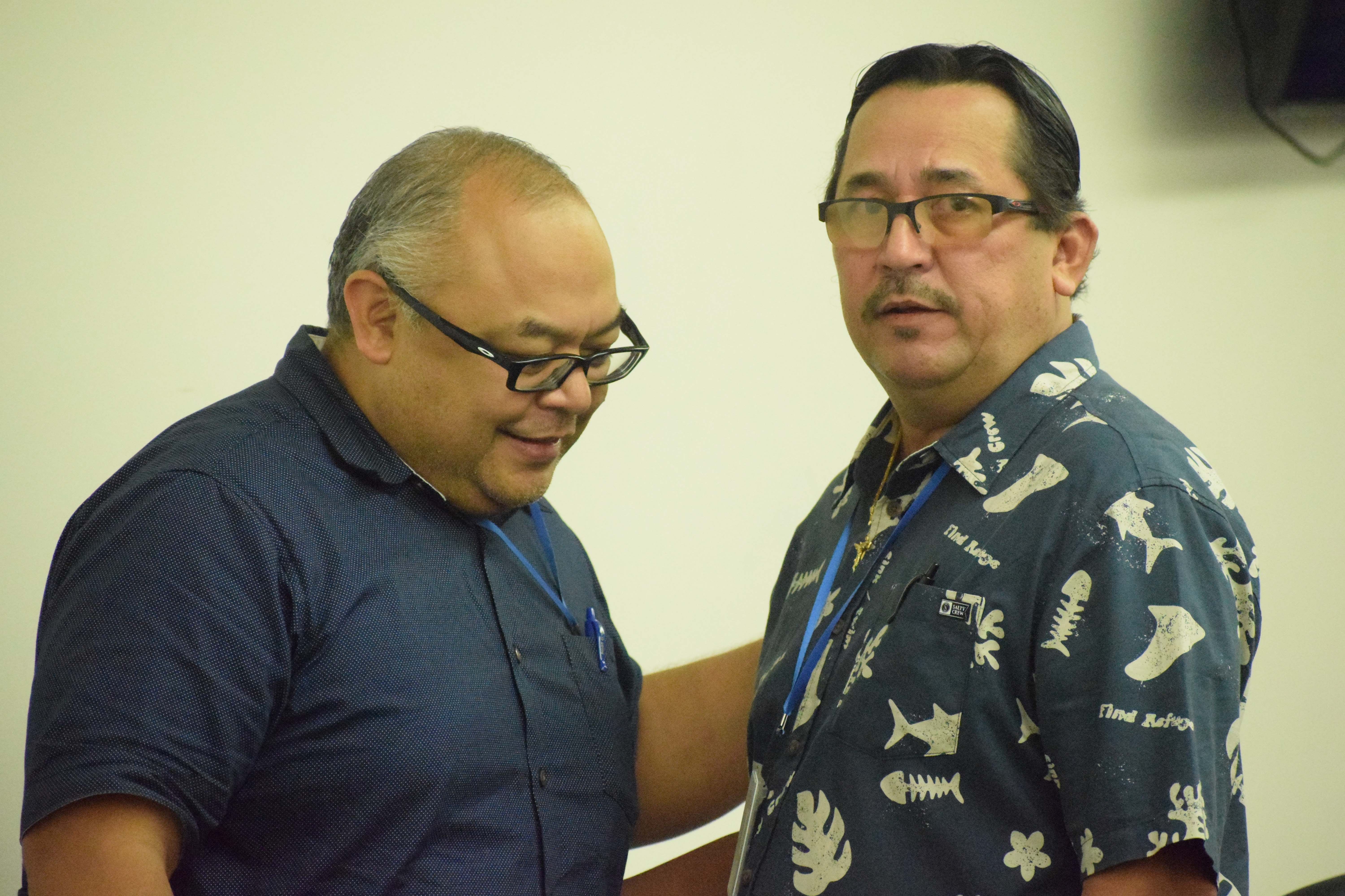 Reps. Blas Jonathan Attao and Patrick San Nicolas confer before the start of the House emergency session on Thursday.