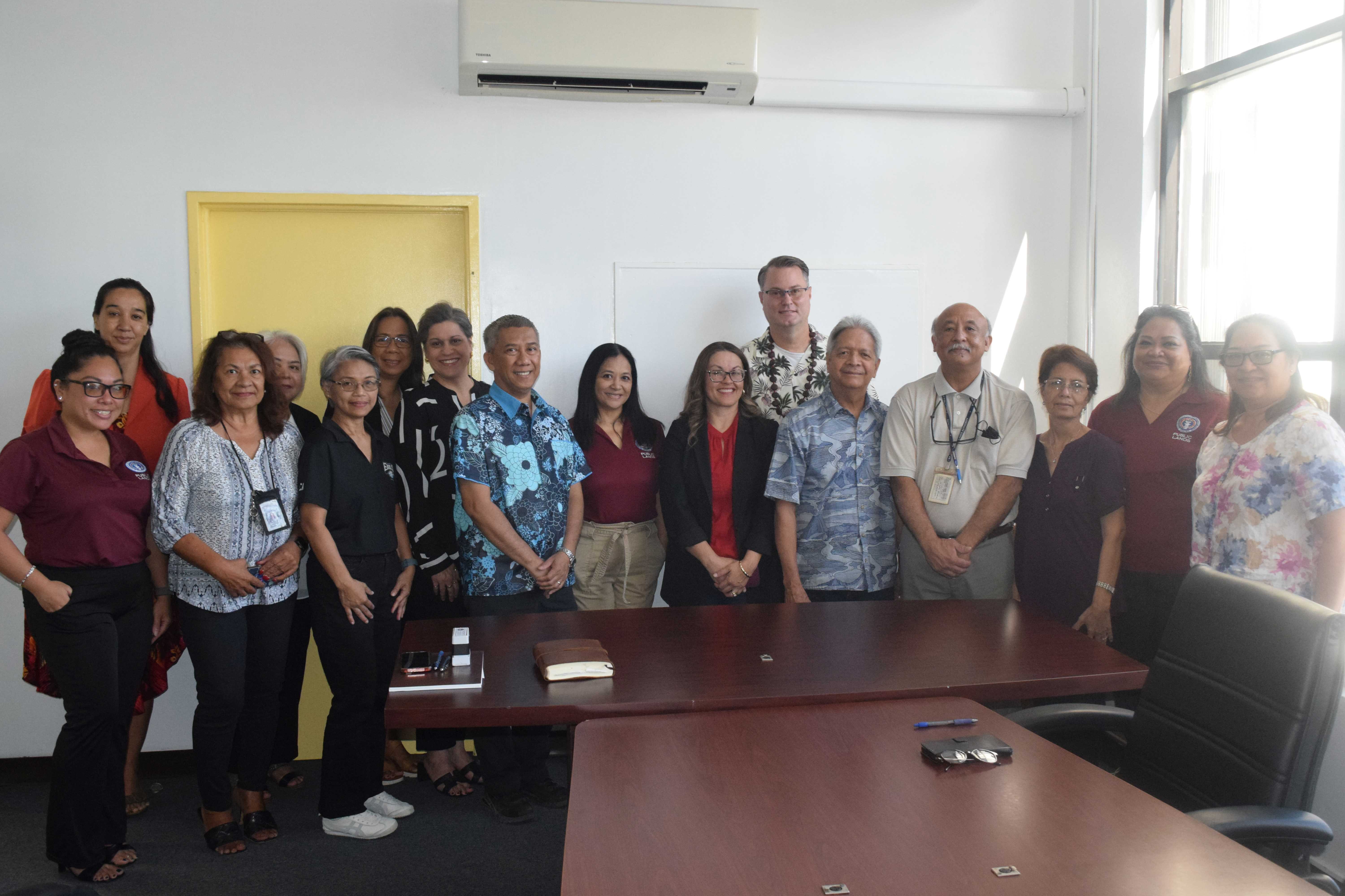 Grace Christian Academy Pastor Michael Rodgers and Special Adviser for the Department of Public Lands David Sablan pose for a photo with GCA and DPL officials and staff after the signing of a new land lease agreement on Friday.