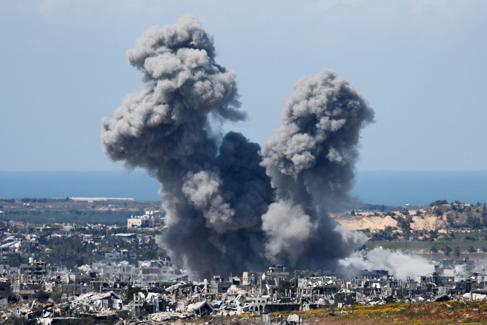 FILE PHOTO: Smoke rises from Gaza during an explosion following an airstrike, amid the ongoing conflict between Israel and Palestinian Islamist group Hamas, as seen from Israel, March 23, 2024. 