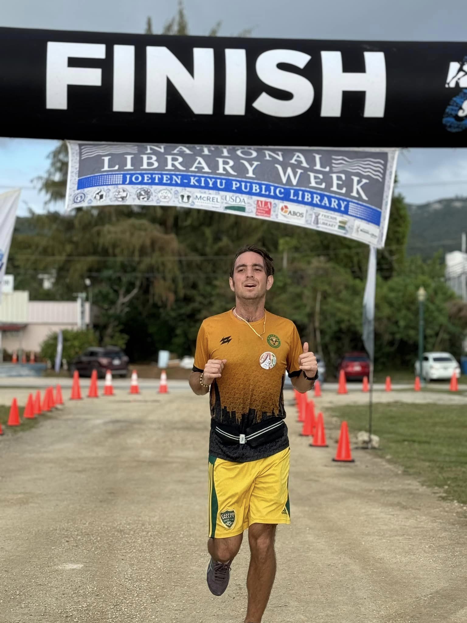 Jordan Ruiz smiles as he finishes first overall in the men's division of the 3rd Annual Friends of the Joeten-Kiyu Public Library 5K Fun Run/Walk at the Garapan Fishing Base on Saturday.