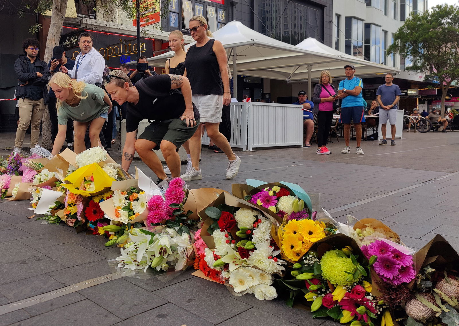 People offer flowers for the victims of Saturday's stabbings at Bondi Junction in Sydney, Australia, April 14, 2024. 