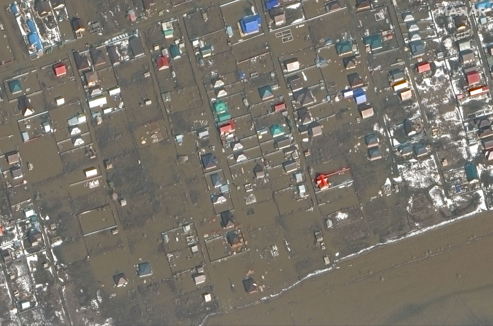 A satellite view shows floodwaters around homes near Orenburg airbase, Russia, April 3, 2024. 