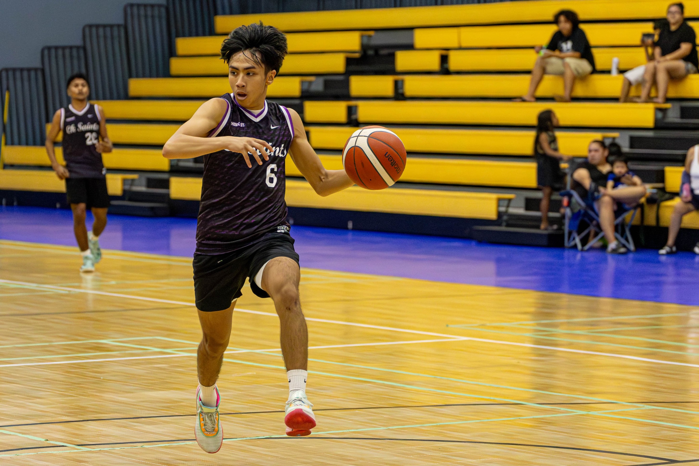 The Saints' JR Thongaram looks behind as he drives for the fastbreak bucket during a game against the Ol'Aces in the Michelob Ultra Cup 2024 at the Ada gym on Tuesday.
