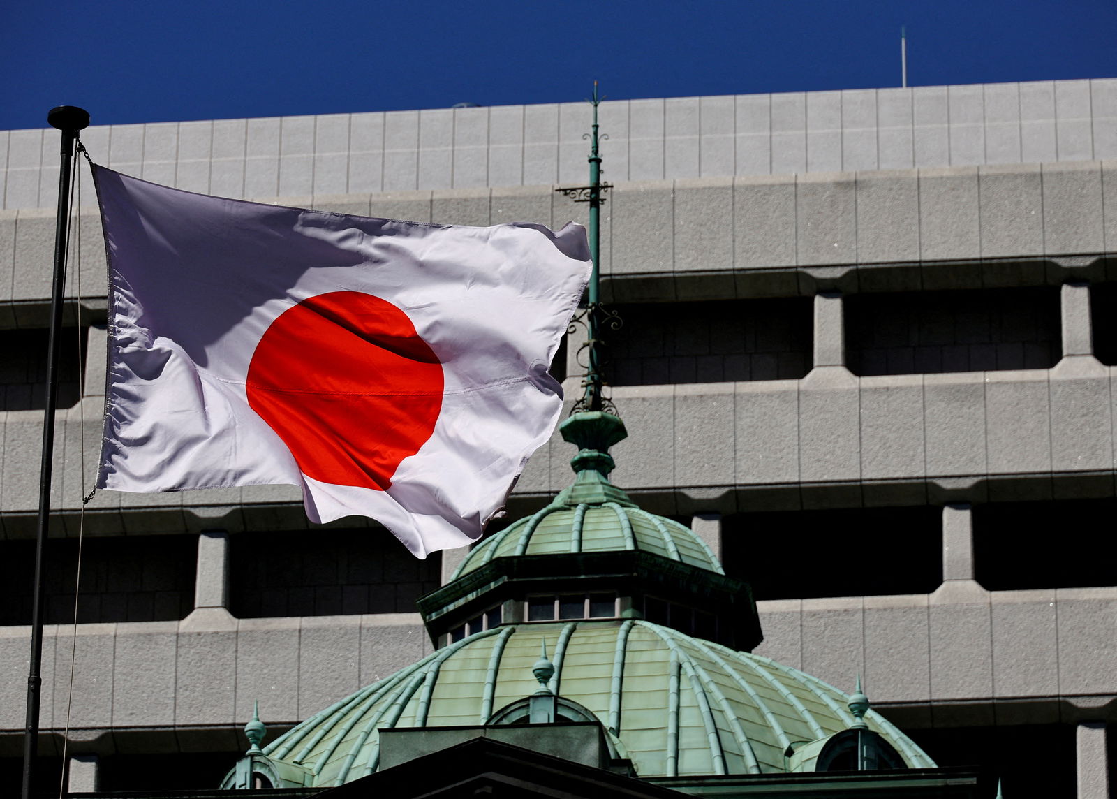 The Japanese national flag waves at the Bank of Japan building in Tokyo, Japan, March 18, 2024. 