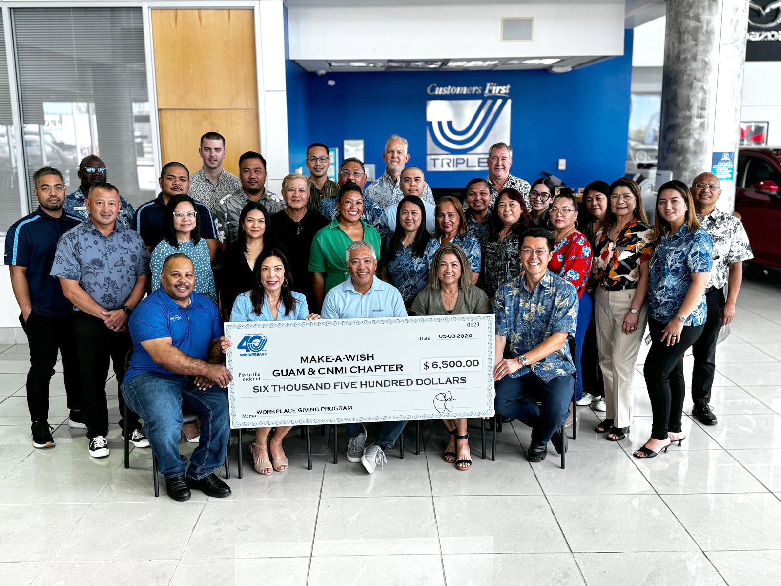 Representatives from Make-A-Wish Guam & CNMI, seated from left : Errol Lee, board member; Kris Lujan, vice chair; Eric Tydingco, president & CEO; Joyce Crisostomo, board member; and Jason Miyashita, board chair, are presented a check for $6,500 from Triple J executives: Jay Jones, senior VP; Dan Murrell, senior VP; Chris Duenas, CFO; Edgar Aguilar, tax director; along with Yolanda Padrones, director of human resources, and some of the 51 employees who take part in Triple J’s Workplace Giving Program.