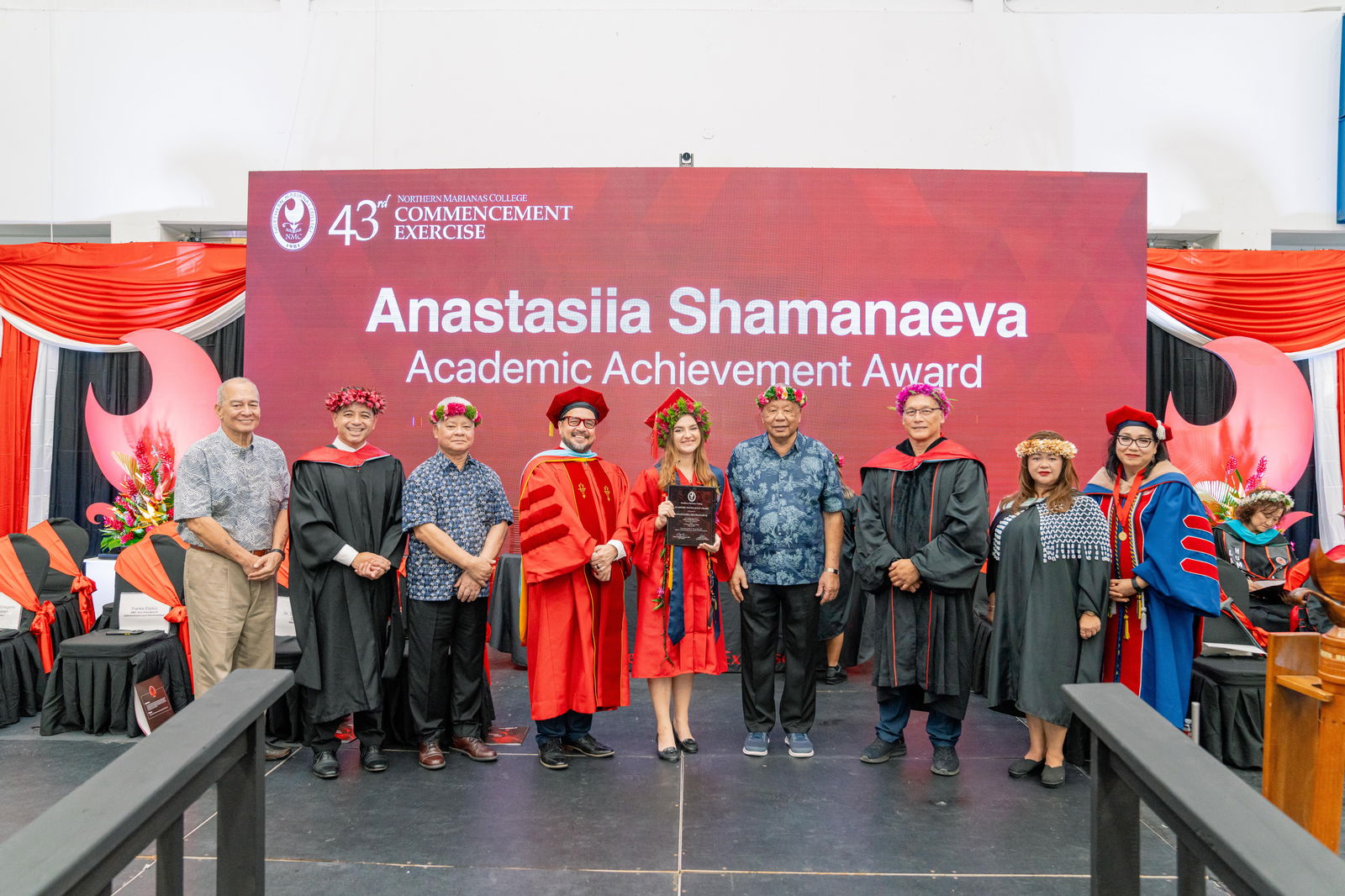 Anastasiia Shamanaeva, who graduated summa cum laude with an Associate of Applied Science in Criminal Justice, was honored with the Academic Excellence Award at Northern Marianas College’s 43rd Commencement Exercise on May 17, 2024, at the Marianas High School Gymnasium. Pictured with Shamanaeva, from left, are keynote speaker U.S. Congressman Gregorio Kilili Camacho Sablan, NMC Vice President for Administration and Advancement Frankie Eliptico, CNMI Gov. Arnold I. Palacios, NMC President Galvin Deleon Guerrero, EdD, CNMI Lt. Gov. David M. Apatang, NMC Board of Regents Chair Charles Cepeda, NMC Dean of Student Support Services Charlotte Cepeda, and NMC Acting Dean of Academic Programs and Services Dr. Barbara Hunter.