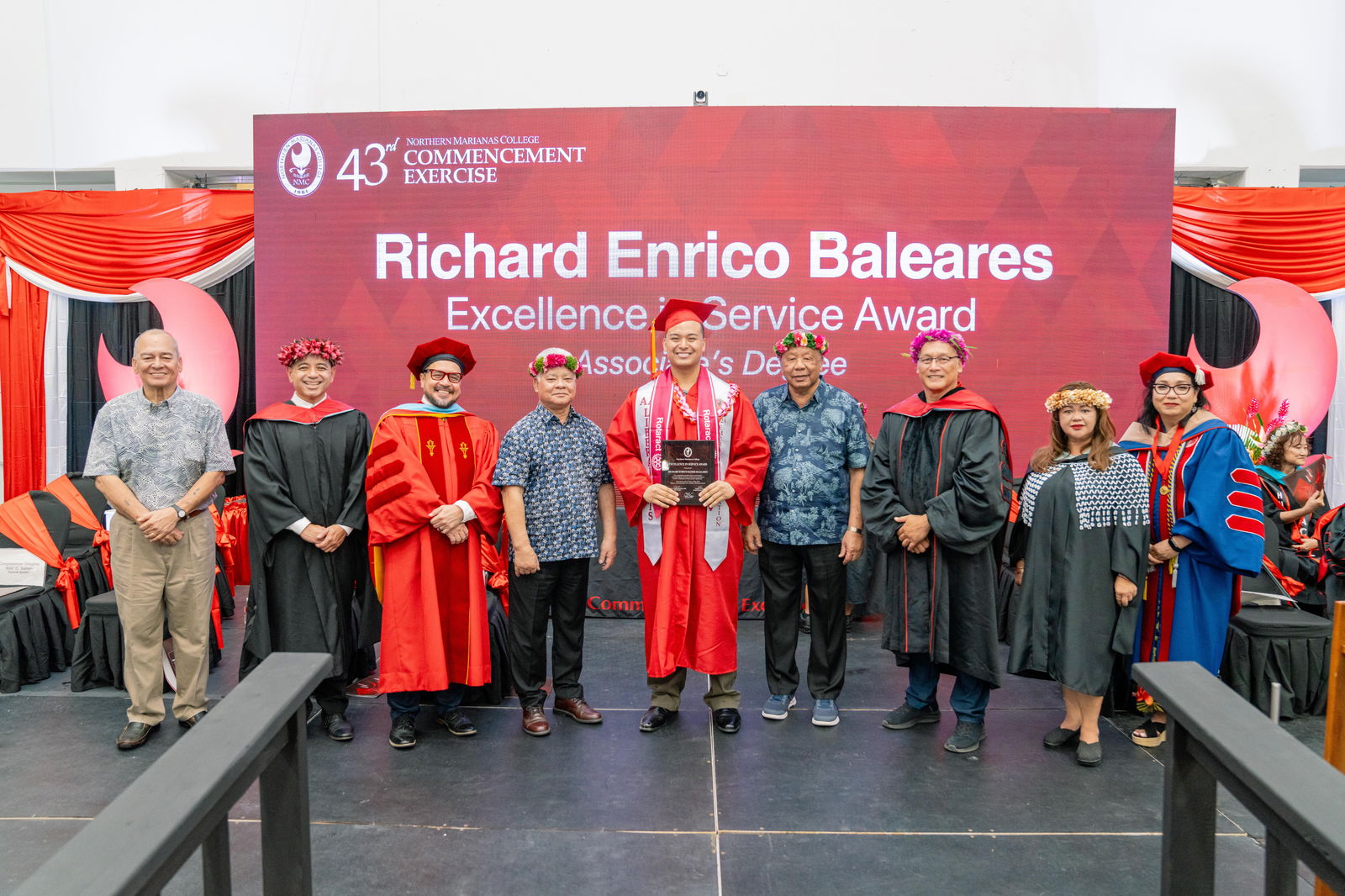 Richard Enrico Baleares, who graduated magna cum laude with an Associate of Arts in Liberal Arts, Education Emphasis, was honored with the Excellence in Service Award at Northern Marianas College’s 43rd Commencement Exercise on May 17, 2024, at the Marianas High School Gymnasium. Pictured with Baleares, from left, are keynote speaker U.S. Congressman Gregorio Kilili Camacho Sablan, NMC Vice President for Administration and Advancement Frankie Eliptico, CNMI Gov. Arnold I. Palacios, NMC President Galvin Deleon Guerrero, EdD, CNMI Lt. Gov. David M. Apatang, NMC Board of Regents Chair Charles Cepeda, NMC Dean of Student Support Services Charlotte Cepeda, and NMC Acting Dean of Academic Programs and Services Dr. Barbara Hunter.