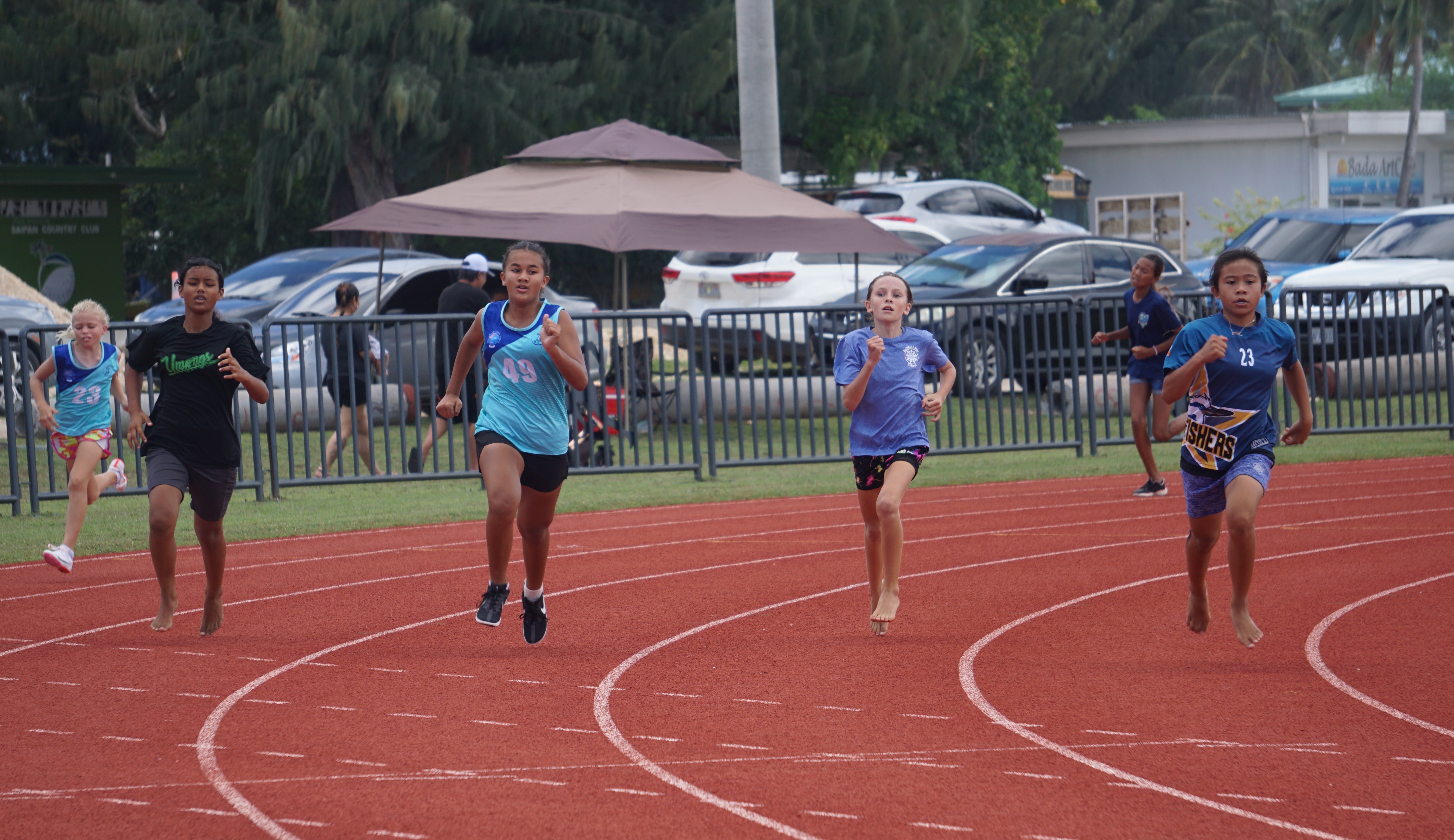 SIS' Windsor Gross leads the U12 girls 400m finals event of the McDonald's-PSS All School Track and Field (Athletics) SY23-24 at the Oleai Sports Complex on Saturday.