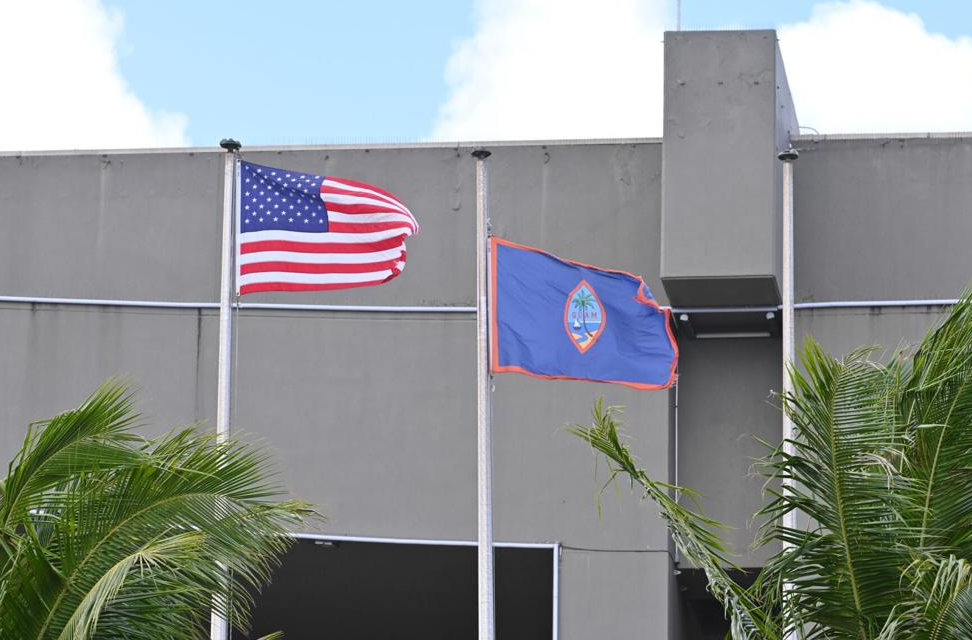 The Guam and U.S. flags wave in the breeze at the Guam International Airport in Tiyan.